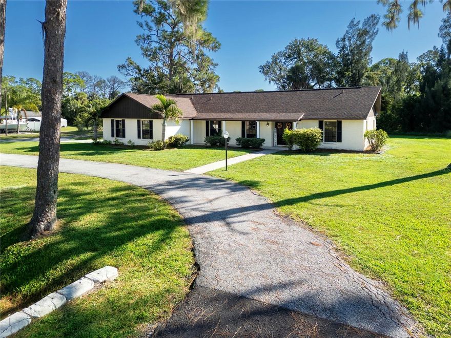Amazing opportunity to own this beautiful pool home featuring 3 bedrooms, 3 bathrooms, and an oversized garage all on over a half an acre. The double front doors, from the circular drive in the front, of the house welcome you in. Notice the luxury vinyl plank floors throughout most of the home and fresh paint as you take in your surroundings. Off to the right are 2 good sized bedrooms, both with 2 closets each, one is even a walk-in, a shared bathroom and hallway with 2 more closets. The shared bathroom has been partly remodeled with a new vanity with quartz counter, waterfall faucet, mirror and lights. To the left of the foyer is the formal living room and dining room, giving lots of space to entertain. Straight through the foyer is an open concept, featuring the Family Room, Kitchen and Dinette. The Family Room boasts a stone front, wood burning fireplace, exposed beam ceiling, and French Doors going out to the pool. The heart of the home is the gorgeous remodeled kitchen with dovetail, soft close, cream cabinets, top molding, stack of drawers, and two tone pulls, quartz counters with room to sit at one end, tile backsplash, under cabinet lighting, new stainless steel appliances and gooseneck faucet over the double deep sink. Enjoy your morning coffee overlooking the pool and backyard in the dinette area. The primary suite is off the kitchen and is large enough for a king size bedroom suite, large walk-in closet and ensuite bath. The ensuite bath has a new vanity with quartz top, make up area, mirrors, and waterfall faucet. It includes a tub with shower and linen closet. The utility room with cabinets above the washer and dryer with utility tub, sits off the kitchen and goes to the garage. It is also the third full bathroom with a walk-in shower stall, private commode and closet for storage. The 30x15 pool has a screened enclosure and 14x13 area under roof for shade. The pool is about 8' deep, has a newer pump and grab bar for the steps. There is another driveway to the garage and it is large enough for 2 cars, has storage cabinets, an extra fridge and is wired for a generator. Additionally, a shed for storage, NO HOA, plenty of parking (even for your boat), roof in 2020 and room to play outside. Call for your Private showing.