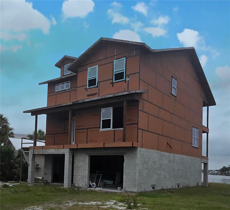 Under Construction. On the water opportunity 3 story home with a great view in desired Indian Rocks Beach!  New construction home 1/2 completed for you to finish to your standards and preferences.  Solid concrete block construction on bottom floor with underground piling foundation for extra wind speed strength. Top 2 floors of living space are frame construction for better energy efficiency, built to 150MPH minimum wind strength!  Home is through frame stage and ready next for insulation and drywall. All mechanical trade rough-ins are completed, except electrical. Still time before drywall to easily change/tweak any currently built wall layouts.  Buyer to finish home from this current stage with all of their color/specification preferences.

Flood zone property, however, zero hurricane damage from any of the large recent storms! Home is built up higher than todays building code standards, so flood insurance is at the most reduced rate. No HOA fees.