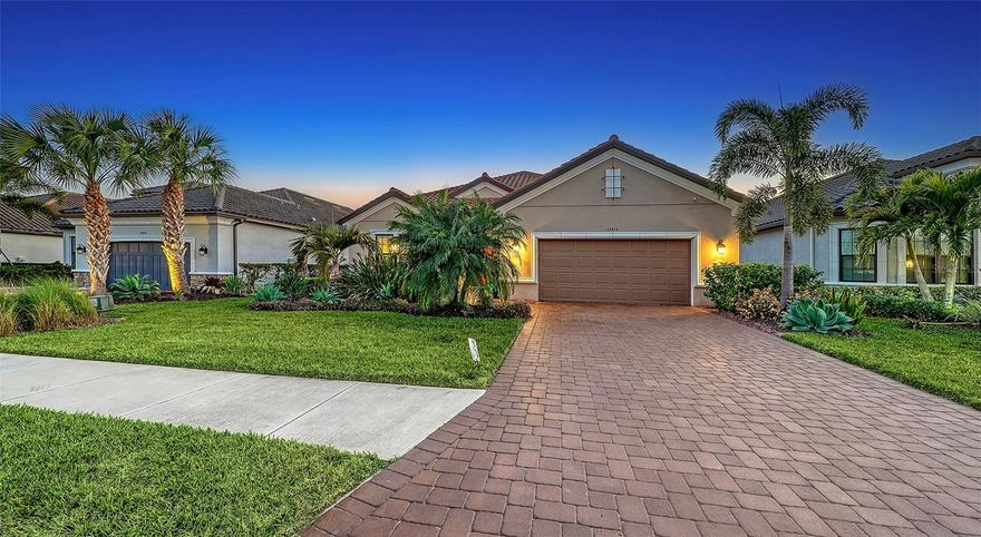 Most sought after golf-deeded Pallazio in Esplanade Azario with the rare and stunning lake and golf views! This home is being offered furnished (some exclusions apply, and yes that is negotiable). Before entering the home, you will be wowed by the gorgeous outdoor landscaping that warms the heart. As you enter this beautiful three-bedroom, three-bath-plus-den home, you will notice all exquisite custom designs in this open floor plan. Beautiful laminate flooring, plantation shutters throughout, tray ceilings and crown molding, designer lighting and fixtures, gourmet kitchen with quartz countertops and soft-close everything. The primary en suite has a lovely sitting area and spa-like bath adjacent to a custom built-in closet. There is a whole-house water filtration and softener, security cameras front and back with home security system. For hurricane protection, there are accordion-style smart guard shutters and a MagnaTrack screen on the lanai. As for storage, the kitchen pantry and main closets have custom built-ins, and the epoxy-finished flooring in the extended garage has two hanging storage units. Go outside to view your personal piece of paradise with the southwest facing views of water and golf (16th hole). With an outdoor kitchen and expanded lanai, here you will experience the most beautiful, peaceful and private sunsets. If you desire a pool and spa, here is your blank canvas with the best backdrop and views awaiting your design. Esplanade at Azario offers world-class amenities including an 18-hole championship golf course, pro shop, culinary center, fitness center, full-service spa, six tennis courts, 16 pickleball courts, a resort-style pool, Bahama Bar & Restaurant, coffee shop and casual pizzeria. (CDD fee is included in annual tax amount.) Ideally near Sarasota’s finest dining, shopping and award-winning Gulf Coast beaches, this home captures the essence of luxury, leisure and lifestyle.