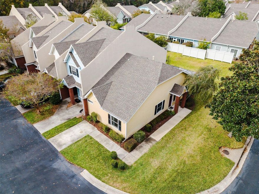 FHA assumable rate of 4.125%! Beautifully maintained 2BR/2BA end-unit townhome (not a condo) in GATED community of Williamsburg in prime NW Gainesville location off 39th Ave & 98th St and a skip & hop to I-75 corridor! Zoned for top-rated Meadowbrook Elem, Fort Clarke MS & Buchholz HS. This charming cottage includes updates like 2019 roof, 2022 LVP floors in main areas, 2022 bedroom carpets, updated premium Andersen windows, 2018 HVAC & water heater. Kitchen features deluxe stainless steel appliances that include  new refrigerator, brand-new range, newer DW, microwave, new big disposal, deluxe deep sink (with cutting board/strainer) & upgraded beautiful faucet.  Security system w/ cameras, sensors & smart switches stay. Newer washer/dryer stay as well! The front entry opens to a welcoming foyer that leads directly to a spacious dining area, great room and kitchen. Great open lay out! The dining room extends onto an oversized screened in porch that significantly enhances the living space.  The owner’s suite, overlooking common area,  is generously sized featuring an es-suite bath with dual vanity & walk-in shower. NEW vinyl floors to be installed in both baths before closing. Indoor laundry, plyboards in attic for some light storage. HOA $216.62/mo includes gated entry, pool, tennis, clubhouse, function rooms, fitness center, library & sauna plus exterior and grounds maintenance. Don't miss this one!