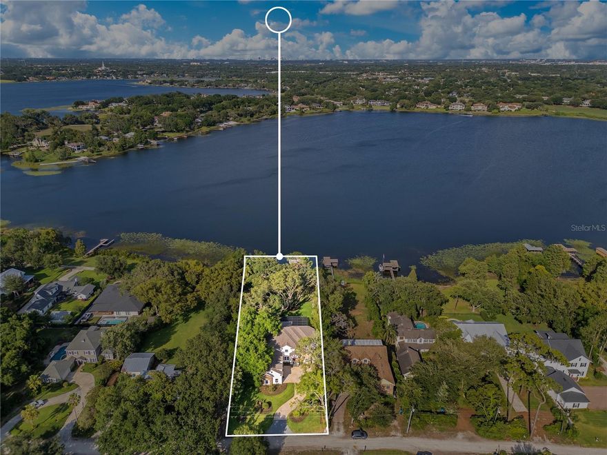 Never Lived In Since Completely Remodeled and Expanded - Total of 6 Bedrooms - 5 Full Baths - 1 Pool or Guest Bath - Primary Suite & Guest Suite on 1st Floor - 4 More Bedrooms & 3 Bathrooms on 2nd Floor - Huge Bonus Room / Theatre / Game Room with Full Bathroom Over Garage - Separate Office on 1st Floor - 12 Foot Wide Folding Glass Doors Overlooking The Screened Pool & Lake Bessie - Newly Expanded Family Room With Expansive Views of Lake Bessie & Screened Pool - Large Covered Summer Kitchen With Natural Gas Grill - Open Kitchen Boasts Custom 54 Inch LED Lit Glass Cabinets - Over & Under Cabinet Lighting - Stainless WOLF 48 Inch 6 Burner Gas Double Oven with Griddle - Custom Designed Arabesque Marble Backsplash with Pot Filler - Built in Stainless Fisher Paykel Fridge Freezer System - Farmhouse Style Island with Table includes Prep Sink with Instant Hot Water Dispenser, Microwave Drawer, Mini Fridge & Extra Storage Cabinets / Drawers - Full Size Kitchen Sink Overlooking Lake Bessie - Extra Bar Top Seating - Designed For Entertaining - The Mud Room / Laundry Room Entrance From Garage has an Additional 36 Inch SubZero Fridge offering the Perfect Place For Bulk Freezer needs or Kids After School Treats - 4 Pantries - Laundry Room Includes Stacked Front Load Washer & Dryer, In The Wall Ironing Board - Steamer, Storage Cabinets & Sink with Lighted Faucet - Oversized 3 Car Garage Includes Storage Racks and Space for a Workshop - Our Exclusive "Car Collector's Package" receives Honeycomb LED Lighting, Custom Wall Colors, EV Charging Station & Custom Color & Designed Epoxy Flooring - New Chamberlain WIFI Garage Door Openers with MyQ App - 1st Floor Primary Bedroom & Closet Has Been Expanded - Separate A/C System for Primary Suite for the Polar Bear Sleeping Experience - Large Shower with Massive Rain Shower & 2 other Shower Heads & HandHeld Wand - Large Slipper Style Soaking Tub - Dual Vanities Having Waterfall Faucets With Elegant Gold Embossed Carrara Marble Geometric Designed Backsplash and Lighted Storage Mirrors - 1st Floor Guest Suite Has Easy Access to Kitchen & Garage - Craft Room or Exercise Room on 2nd Floor Overlooks Lake Bessie - 2nd Floor has A/C System - 1st Floor has A/C System - All 3 Thermostats Have WIFI Control App - Pool Has Been Completely Remodeled With Multicolor Pool Light, Pebbletec, Blue Glass Tile, Waterfall & 2 Towers with Natural Gas Fire Pots - Boathouse Has An Aluminum Cradle Lift Able To Handle A Large Air Nautique or Ski Boat - Lake Bessie has Spring Fed Crystal Clear Water & a White Sand Beach – Golf Cart Friendly Community - Monthly Foodtrucks & Farmer's Market Every Friday - Must See To Appreciate The Benefits Of Purchasing A Move In Ready Lakefront Home