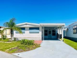 Great 2 bedroom, 2 bath house on a great street in desirable Country Club Estates. Tile throughout except for bedrooms. Plenty of storage in outside enclosure, off lanai. Golf cart to all amenities, restaurants and Publix.