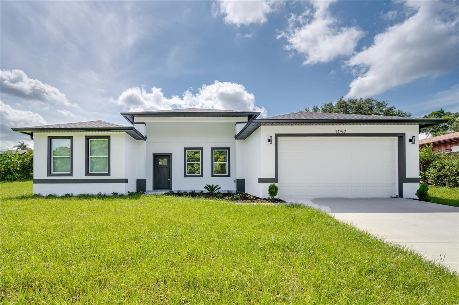 Stunning New Home in Deltona — Where Modern Design Meets Exceptional Living! Step inside this exquisite new block home offering 1,700 sq ft of beautifully designed living space (2,469 sq ft total), wrapped in elegant finished stucco. Located across from Vann Baseball Field Park, this home blends sophisticated style with unbeatable convenience.
Highlights You’ll Love:
Grand open-concept layout with chic matte black finishes, creating a bold yet timeless atmosphere.
Inviting foyer opens to a spacious great room, perfect for entertaining family & friends.
Chef-inspired kitchen features a dramatic 10-foot island, sparkling quartz countertops, 42” soft-close cabinetry, stainless steel appliances, double pantry cabinets, plus a built-in bar area ready for your wine fridge.
Seamless flow to the covered lanai, ideal for relaxing afternoons or evening gatherings. Private Retreats:Owner’s suite is a true sanctuary with double windows for extra natural light, his & hers walk-in closets, and a luxurious ensuite bath showcasing a large walk-in shower, dual sinks, private toilet, and floor-to-ceiling designer tile. Split-bedroom layout ensures maximum privacy, with spacious guest bedrooms sharing a gorgeous second bathroom featuring dual sinks and tiled walls to the ceiling. Thoughtful Upgrades Throughout: Oversized laundry room with utility sink. Larger-than-average garage with epoxy floors & automatic opener. Seamless rain gutters complete the home’s polished look. NO HOA - NO CDD
The Perfect Location: Nestled in the heart of Deltona—close to state parks, crystal-clear springs, shopping, restaurants, and just 30 miles to Lake Eola & downtown Orlando. Plus, you’re a quick drive to Florida’s stunning Atlantic beaches.
Don’t miss this opportunity to own a spectacular home that truly checks every box! Call or message today to schedule your private tour — before someone else claims your dream home!