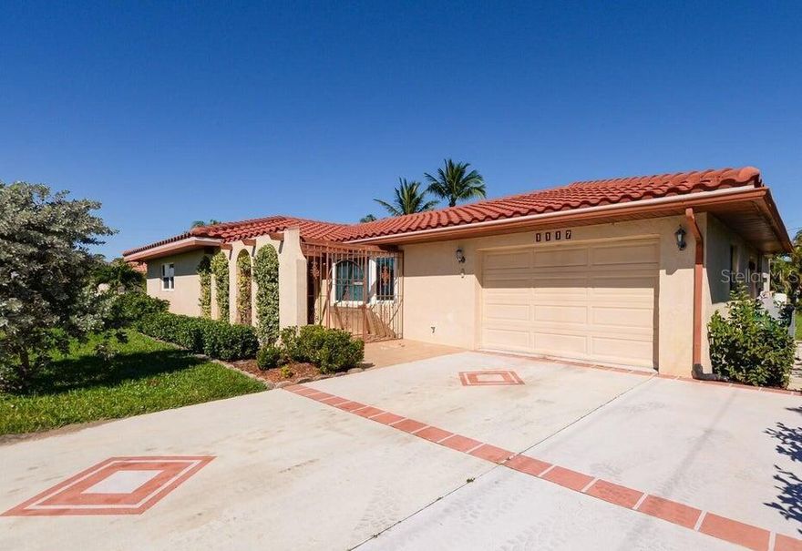 Charming CBS home with spacious living room and family room. Open kitchen with granite countertops, breakfast bar and dining area. Beautiful stone fireplace in family room. Living room with bay window, overlooks front gated porch. Primary suite with walk in closet, tile shower, side slider to private patio. Bedroom windows, bay window in living room and primary bedroom slider impact glass. Enclosed bonus room under air could be used as third bedroom or office space. Extended decorative driveway. Barrel tile roof 2016, AC 2019, water heater 2018. Located minutes to shopping and restaurants.