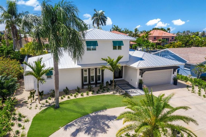 STUNNING!!!!! New and unique to the market, a 5 bedroom 4 bath pool home.  This home is a boaters dream and can accommodate a large family. We are very proud to present this gorgeous and beautifully appointed home in the Bay Palms neighborhood . It may as well be described as new construction with every detail being updated from behind the walls out.  As mentioned this home boasts 5 bedrooms in a split floor plan and 4 full baths, one of which can also serve as a convenient pool bath with an exterior entrance.  It also features a 2 car garage with circular drive, brand new landscape, remodeled pool/jacuzzi with circular rim flow spa, twilight lighting accents,  three fountains, an upstairs bonus space with 2 more bedrooms and baths, along with a large outdoor upper sun deck for looking out over the island views and canal. This home has been completely remodeled down to the studs, leaving no stone unturned. Trust me when I say: no stone unturned and amazing attention to detail. From the moment you walk into this home you experience a beautiful open concept floor plan with custom built in entertainment center and storage and large oversized kitchen and island.  The owners even repurposed the original front doors and turned them into an artistic feature in the home.  Everything in this home is brand new, roof, AC downstairs and duct work 2022 and upstairs AC unit 2016, windows, doors, plumbing, electric, drywall, bathrooms, kitchen, appliances, flooring, paint, pool and pool equipment , and landscape.  Literally the list of upgrades truly does go on and on. This is a brand new home. The attention to detail will not disapoint the new owner of this home. If you are looking for a move in ready gorgeous full time home, or a second home, this one is a must see.  If Anna Maria Island is your destiny then this home is calling your name.  Schedule your private showing today for this one of kind large 5 bedroom Bay Palms luxury canal home. Sold with furniture in photos.