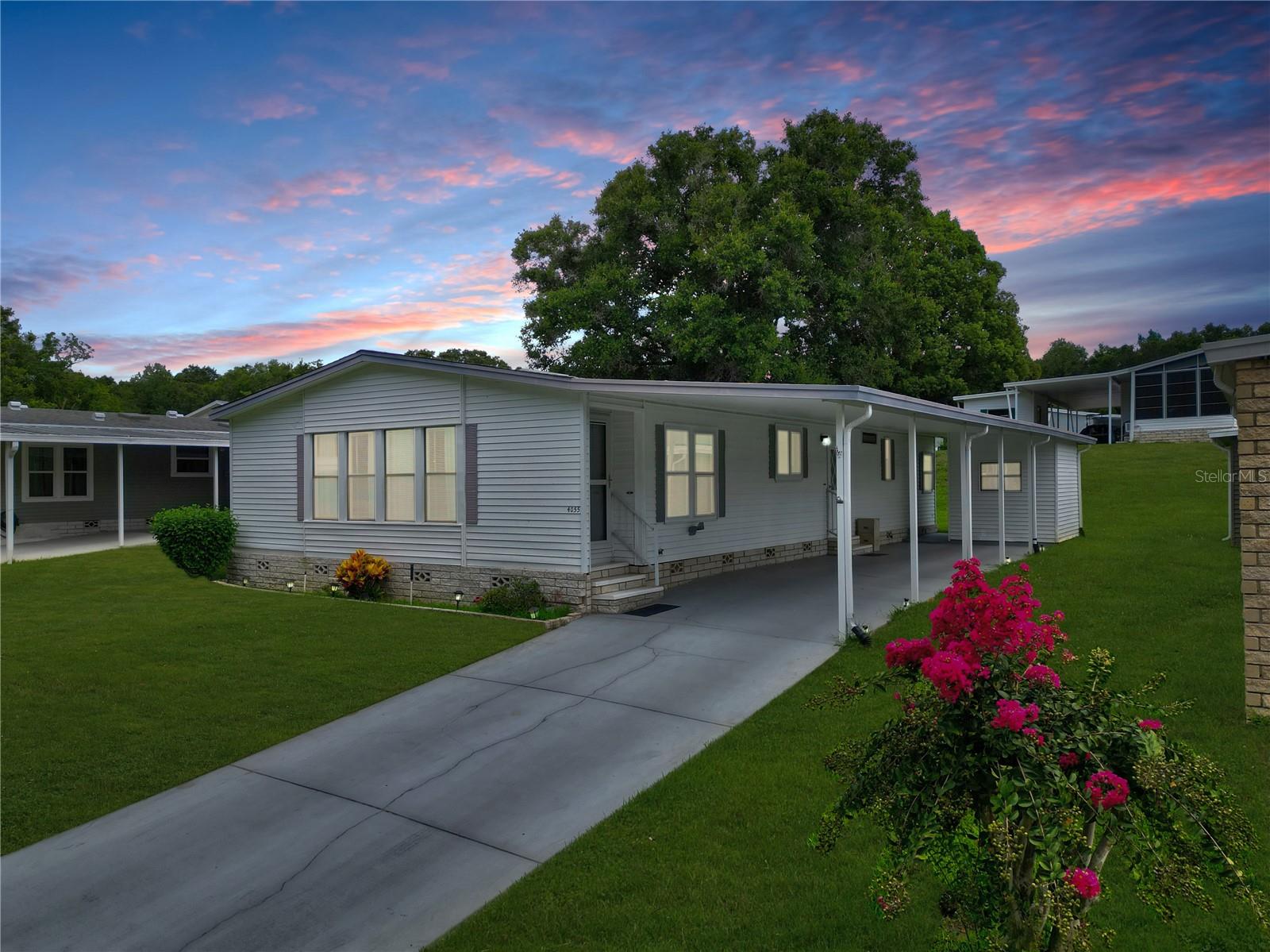 This beautiful open floorplan 2 bedroom/2 bath overlooks some of the best views in the community. New Roof 2018, Annually Serviced A/C, Inside Laundry (washer/dryer convey) HOME WARRANTY included. Spacious Living room with wood burning fireplace (electric insert) overlooks the park like setting with mature trees, blue skies, the lake, birds & butterflies offering a tranquil setting for this phase of your life. The formal dining room has spacious built in cabinetry & opens both into the well appointed kitchen and through French doors onto your All-Season Porch for even more dining capacity. Your spacious guest bath is adjacent to a generous sized guest bedroom. Enjoy your primary bedroom's high ceilings and huge walk in closet. Then open the French Doors into your Primary bath with double vanity, tons of storage and the walk in shower. But don't get too comfortable....there's always something to do. More activities than you will ever have time to do. Full Service Restaurant, Entertainment every Friday night, Bingo multiple nights, Line Dancing, a Gym, Woodworking shop, Stained Glass, 4 pools, water aerobics and a Championship Golf course. Manned Security Guard Gate 24/7 & On Site Park Management Staff. RV Storage Lot. LOW HOA includes Lawn, Trash, High Speed Fiber Optic Internet and Cable, Security & use of all the amenities. Ask about our Reduced Greens Fees. THIS COULD BE YOUR HOME, SET AN APPOINTMENT TO COME SEE IF FOR YOURSELF! Zellwood Station, where The Good Life Begins!
