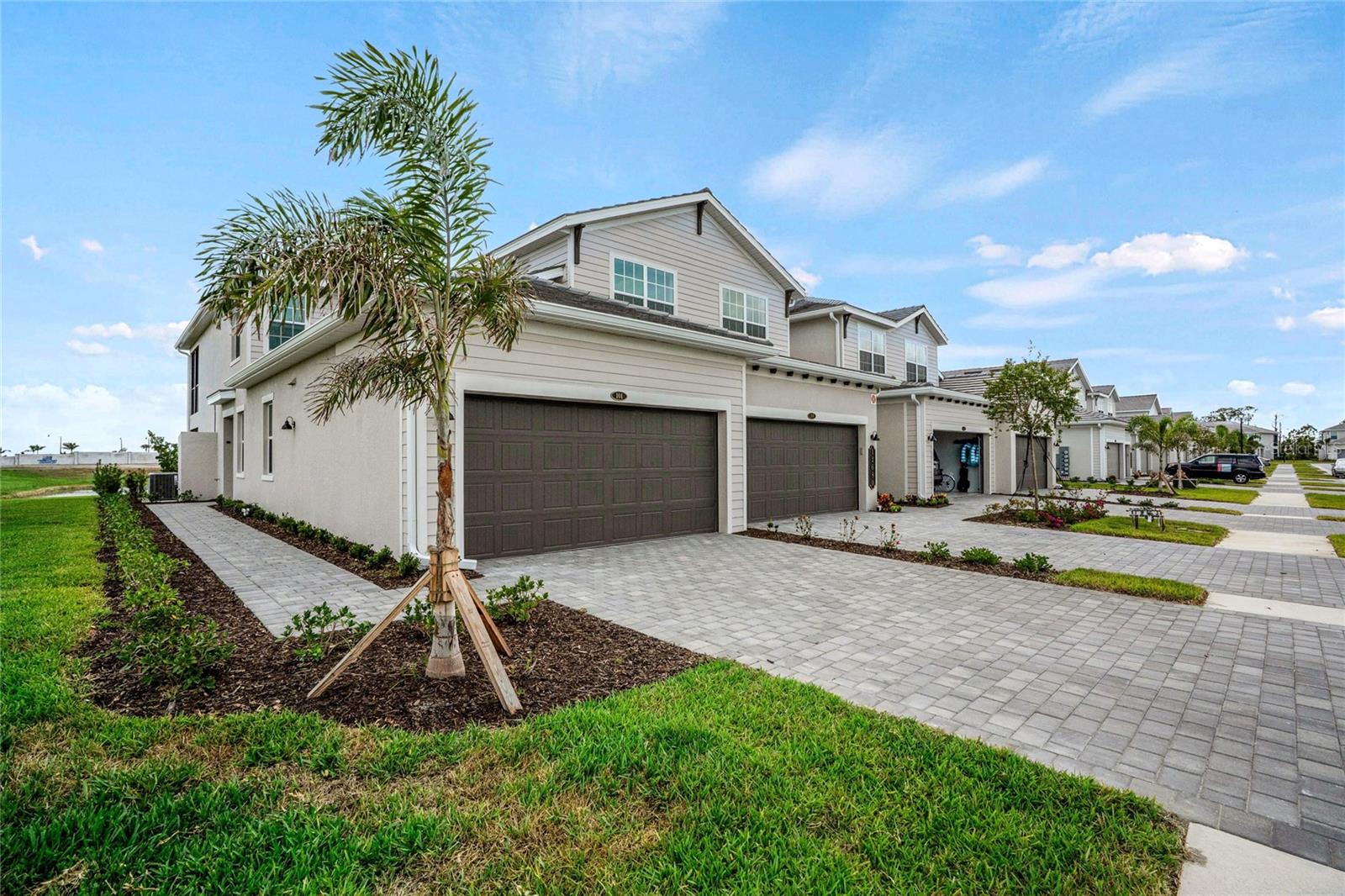 PRICE JUST REDUCED! NEW, never-lived-in, MOVE-IN-READY Lakefront Coach Home with bundled GOLF MEMBERSHIP in Wellen Park Golf and Country Club! Forget the months-long construction delays and bypass the $3,000 builder fee! This stunning home is completed and situated on a coveted LAKEFRONT end-of-the-street location. This impressive 3 bedroom, 2 bathroom, 1741 square foot, first-floor residence is well designed for modern living and has a large screened lanai with serene views. The open concept great room features a gorgeous kitchen with island plus spacious living and dining areas with upgraded tile flooring throughout. Beautiful quartz countertops grace all cabinetry and the spacious owner's suite feels spa-like with it's designer fixtures and large tiled shower. Two additional bedrooms provide flexible space for an office and guests with a large hall bathroom nearby. Important practical attributes like hurricane impact windows, smart home features, energy efficient new appliances and eco-friendly landscaping are present and add to the maintenance-free experience. Your neighborhood golf course is a Gordon Lewis 18-hole championship course with a new clubhouse to be completed in 2026. Enjoy food and cocktails at the tiki bar or relax in your cabana at the first class resort-style pool. Other amenities include a premier fitness center, various sports courts, biking and walking trails and a wellness center with yoga room and full-service spa for massages, etc. HOA fees include bulk cable and internet, water, sewer, trash collection, exterior building maintenance and insurance, landscaping maintenance and reserves. Downtown Wellen has a community focus with multiple shops and boutiques, live music almost daily, numerous dining options, a lakefront trail, kayaking, family events and other outdoor recreation options. Several area beaches, parks, historic downtown Venice and I-75 are just a short drive away. Don't miss the opportunity to make this impressive coach home yours and join the exceptional community of Wellen Park Golf and Country Club. Schedule a private showing today!