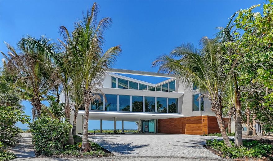 Under Construction. You're in for something special with this new beachfront construction set to be completed by May, 2026. Located on over a quarter acre on Longboat Key, this contemporary luxury home is directly on the beach with stunning Gulf views. Designed with a modern coastal aesthetic, it’s built for both style and comfort. Inside no detail is overlooked. From sleek Walker Zanger porcelain tile to custom cabinetry and polished nickel fixtures, the finishes are top-tier. The gourmet kitchen features an expansive layout with a large waterfall-edge island, double Wolf ovens, Sub-Zero refrigeration, a full-size wine cooler, and a Wolf induction cooktop—everything you need for serious cooking or entertaining. Primary suite is a true showstopper with floor-to-ceiling glass sliders that open wide to a sweeping terrace. Gulf breezes flow through the space, and the shimmering azure water is always in view. Inside, the suite offers a spacious walk-in closet and a spa-like bath featuring tiled walls, a walk-in shower with multiple heads, a soaking tub, dual floating vanities, and a private water closet. Upstairs, an executive office and three generous bedroom suites—each with its own walk-in closet—gives plenty of space for family or guests. A fourth bedroom shares a cozy den, perfect for lounging or movie nights. The grand-level outdoor space takes full advantage of its beachfront setting with a 36-foot lap pool, sun shelf, heated spa, and a fully equipped summer kitchen with a grilling station—ideal for effortless entertaining, all just steps from the sand.