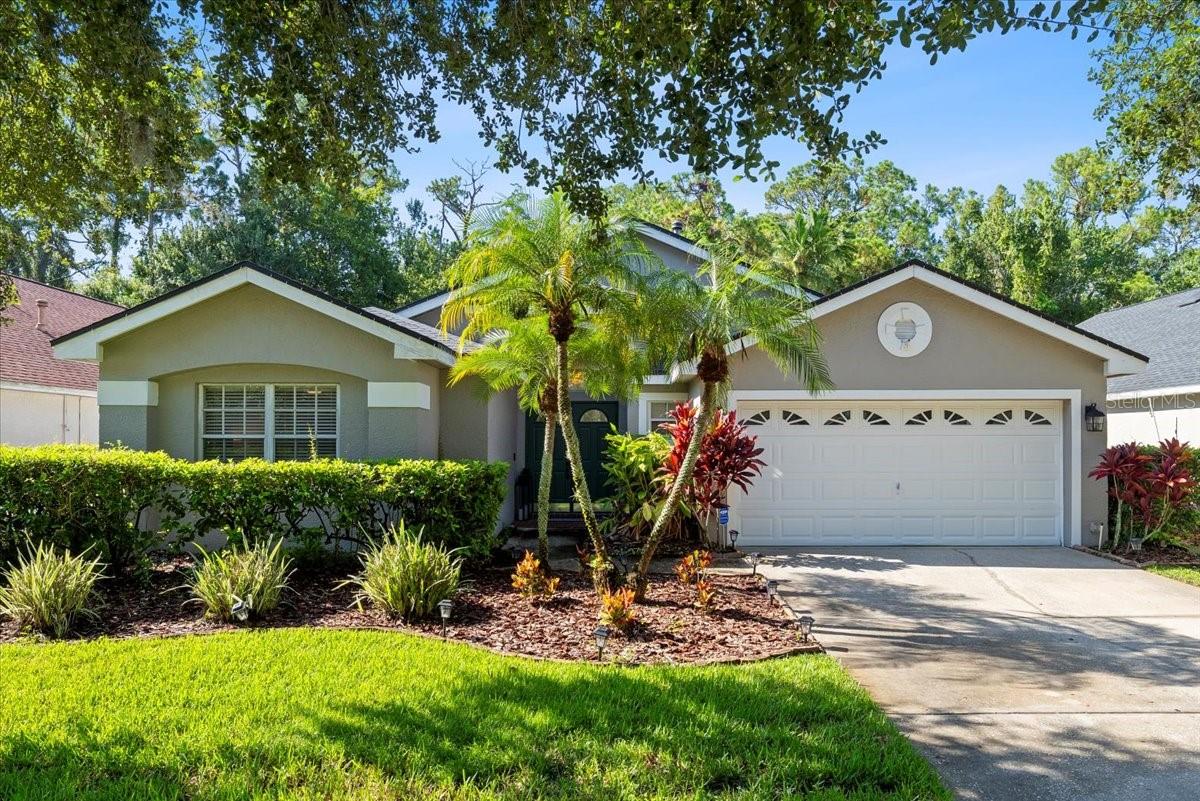 Fantastic opportunity to live in the friendly neighborhood of The Shires in Westchase! This exceptional 3-bedroom, 2-bath home offers a thoughtfully designed layout boasting a standout Florida Room addition and tasteful updates throughout. Architectural touches including arched doorways, decorative windows, and alcoves enhance the home’s aesthetic appeal, while vaulted ceilings and the abundance of light from the transom windows, French doors, and triple glass sliders create an open and welcoming living space. The updated kitchen features stainless steel appliances, ceramic tile flooring, solid surface countertops, and a breakfast bar that seamlessly connects to the family room. The family room, complete with a cozy gas fireplace, flows effortlessly into the sun-filled Florida Room through elegant French doors—creating a continuous and inviting space. The Florida room adds valuable living space and versatility—perfect for a home office, playroom, or simply a quiet place to take in the view while staying cool in air-conditioned comfort. Triple sliding glass doors in the living room open wide to connect a spacious screened-in covered patio, offering a protected outdoor setting ideal for year-round enjoyment. With attractive paver tile flooring, two ceiling fans, and plenty of space for dining, lounging, or entertaining, it’s the perfect spot to relax or host guests. Just beyond, the large, fully-fenced backyard provides a lush grassy area for pets, play, gardening, or a fire pit—all backed by a serene conservation area with no rear neighbors. The split bedroom design provides convenience and privacy. The spacious primary suite includes an ensuite bath (updated in 2023) with a modern dual-sink vanity, a soaking tub, and a stand-up shower. Westchase is one of Tampa Bay’s most sought-after communities, known for its resort-like amenities including two pools, tennis and pickleball courts, playgrounds, parks, and a vibrant village center filled with restaurants, shops, and events. You're just minutes from Publix, 4 miles to Citrus Park Mall, 12 miles to Tampa International Airport, and about 20 miles to the sandy Gulf beaches. Quick access to the Veterans Expressway makes commuting to Tampa or St. Pete easy and convenient. Don’t miss your opportunity, schedule your private tour today!