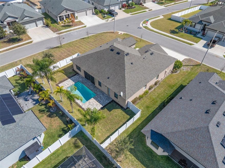 One or more photo(s) has been virtually staged. Welcome to Villa d’Este at Cypress Creek, a sought-after GATED community welcoming residents of all ages with No CDD fees, a low HOA, and No flood zone. This private pool home is situated on an oversized, fully fenced corner lot offering exceptional privacy and outdoor space. Built by William Ryan Homes, the popular Canaveral floor plan showcases impressive architectural details, including elegant columns framing the covered front porch and a spacious three-car garage. With just under 2,200 square feet of living space, this thoughtfully designed home features 4 bedrooms, 2 full bathrooms, and an office. Elegance, comfort, and modern finishes blend seamlessly with arched entryways, high ceilings, crown molding, 8’ doors, and a passthrough adorned with a custom-made feature. The Great Room serves as the heart of the home, thoughtfully designed for both everyday living and effortless entertaining. The spacious layout easily accommodates oversized furnishings, creating a comfortable and inviting gathering space. The gourmet-style kitchen features wood cabinetry, granite countertops, top-of-the-line stainless steel appliances, including a wall convection oven, and timeless finishes. The breakfast bar is the perfect spot for guests to gather, while the adjoining dining area provides a welcoming space for casual, everyday meals.  Enjoy seamless indoor-outdoor living with the covered and screened rear lanai, ideal for relaxing and enjoying the Florida weather. The sparkling saltwater pool features a premium PebbleTec® finish, child safety fence, and convenient outdoor shower. The fully fenced backyard offers plenty of space for pets and play, framed by mature Queen palms and a solar-lit fence that enhances the tropical setting.  Back inside, the spacious primary bedroom features a striking accent wall, ample room for king-size furnishings, and an updated oversized ceiling fan. The en-suite bathroom is equipped with dual sinks, granite countertops, upgraded fixtures and mirrors, an oversized walk-in shower, a soaking tub, and a separate water closet. Three generously sized secondary bedrooms offer comfortable accommodations and convenient access to the second full bathroom, complete with a walk-in shower and direct pool access. The interior laundry room adds everyday convenience, while the spacious three-car garage includes an electric vehicle charger and ample room for vehicles, bikes, a golf cart, and additional storage. This pet-friendly community offers quick access to shopping and restaurants and is just minutes from I-75 and local golf courses, including Cypress Creek—an active course featuring a full-service pro shop, lessons, and a restaurant open to the public.  This exceptional home offers the perfect blend of privacy, luxury upgrades, and an active Florida lifestyle in one of Sun City Center’s most desirable gated communities.