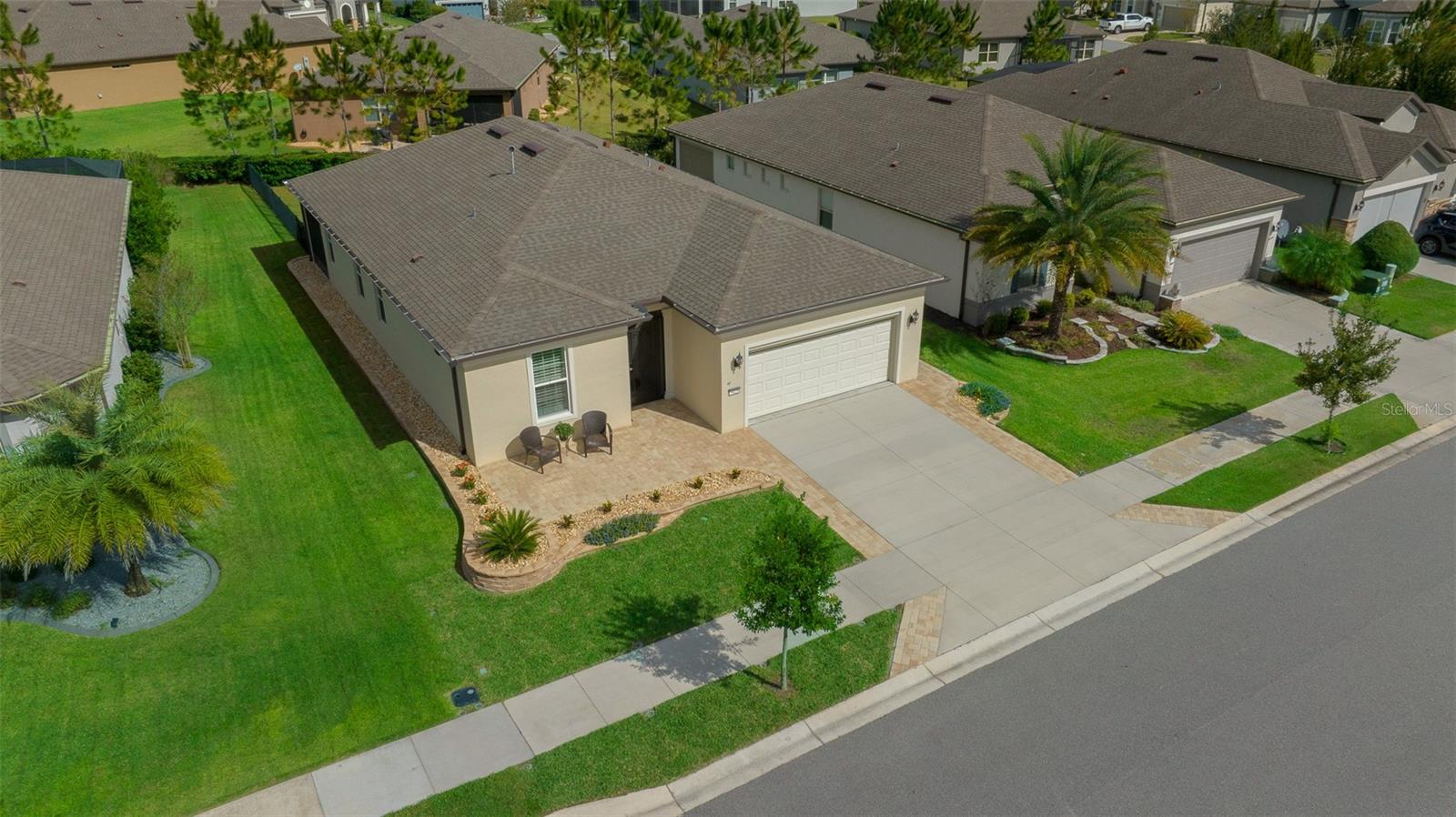 Stunning Mystique Model in Highly Sought-After Stone Creek/Del Webb 55+ Community. Welcome to this beautifully maintained Mystique model home, nestled in the vibrant and amenity-rich Stone Creek by Del Webb—a premier 55+ gated community. This elegant single-story residence offers 1,891 sq. ft. of thoughtfully designed living space, featuring 2 spacious bedrooms, a versatile office/den, and 2 full bathrooms, all crafted for modern comfort and timeless style. From the moment you arrive, you'll notice the custom paver driveway and patio extensions, lush fresh landscaping, and charming screened-in front porch. Step inside to discover custom crown molding, elegant louvered window treatments, and brand new plush carpeting that elevate every room with a refined touch. The heart of the home is the bright, modern kitchen, showcasing granite countertops, updated cabinetry, designer pendant lighting, stainless steel appliances, and a walk-in pantry—ideal for both daily living and entertaining. The kitchen seamlessly opens to a spacious living and dining area, featuring a remote-controlled sliding door blind that leads to the screened-in lanai and large, private fenced backyard, perfect for outdoor enjoyment.
The luxurious Owner’s Suite offers a serene retreat with a spa-inspired walk-in super shower, dual vanities, and an expansive walk-in closet. Every inch of this home reflects pride of ownership and thoughtful upgrades.
Additional highlights include:
Tandem 2-car garage + golf cart space with epoxy-coated floors, screen door, and overhead storage. All appliances included – washer and dryer too! Screened lanai for year-round outdoor living.
Enjoy the best of active adult living with three recreation centers, including the brand-new Stone Water Club featuring a beer & wine bar, resort-style lagoon pool, indoor lap pool, spas & saunas, fitness center, and walking trails. Take advantage of pickleball, tennis, shuffleboard, bocce, basketball, and even a softball field. There’s also a public golf course, fishing ponds, and a dynamic social calendar packed with clubs and community events.
This is more than a home—it's a lifestyle. Don’t miss your opportunity to own this move-in ready gem in one of the area’s most desirable 55+ communities and be sure to check out the virtual tour link for a room-by-room look at this exceptional property!