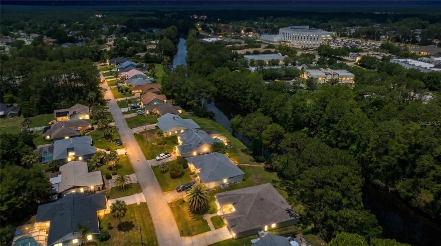 Welcome to 68 Webster Lane, a custom-built Red Carpet Home offering 2,166 square feet of thoughtfully designed living space overlooking a peaceful freshwater canal in the heart of Palm Coast. Built in 1993 by Red Carpet Homes, a builder recognized for creating higher-end custom residences with quality craftsmanship and distinctive architectural design, this spacious 3-bedroom, 2-bath property showcases soaring vaulted ceilings, dramatic ceiling heights, transom windows, architectural columns, and expansive living areas rarely found in today’s production-built homes.

One of the standout features of this property is the incredible 639-square-foot enclosed sunroom/multipurpose space overlooking the freshwater canal and natural preserve backdrop. Connected to the interior through three sets of pocketing sliding glass doors from the primary suite, living room, and family room, this oversized space creates seamless indoor-outdoor living ideal for entertaining, relaxing, hobbies, fitness, or additional gathering space. The backyard offers long canal views framed by mature trees, creating exceptional privacy and a tranquil natural setting with room for a future pool, outdoor entertaining area, or observation deck.

The split floor plan offers generous room sizes throughout, including a spacious primary suite featuring dual walk-in closets, dual vanities, a garden soaking tub, walk-in shower, and enclosed water closet for added privacy and functionality. A separate guest suite area is tucked behind a pocket door, creating additional privacy for visitors or multigenerational living. The kitchen overlooks the main living spaces and breakfast nook area, providing an open flow ideal for everyday living and entertaining. Additional highlights include an oversized 2-car garage, abundant natural light throughout, and major system updates including a roof replaced in 2015, HVAC in 2019, and water heater in 2019.

Conveniently located near shopping, restaurants, golf courses, and the new AdventHealth Hospital on Palm Coast Parkway, this property also offers easy access to miles of pristine beaches along Flagler Beach and the Hammock, including nearby Jungle Hut Beach known for its unique coquina rock formations and scenic shoreline walks. Historic downtown St. Augustine is approximately 30 minutes away, while both Daytona Beach International Airport and Jacksonville International Airport provide convenient travel access. Palm Coast continues to gain attention as one of Florida’s hidden gems, offering a relaxed coastal lifestyle without the congestion of larger South Florida markets.

If you are searching for custom construction, exceptional living space, peaceful water views, and the opportunity to personalize a well-built property with architectural character in a desirable Palm Coast location, 68 Webster Lane is a must-see.