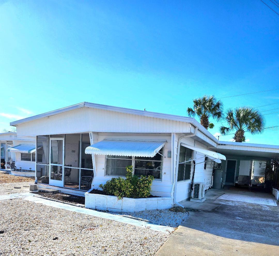 FRONT PORCH SITTIN' with a FULL MARINA VIEW! Located across the street from the Trailer Estates Marina, 2 Bedroom, 2 Bath mobile home with block construction addition. Dock your boat just steps from your front door! A little TLC needed, otherwise this is a solid unit situated on a slightly oversized corner lot in the highly desired, 55+ Trailer Estates community. Updated Kitchen cabinets with beautiful tile backsplash. Luxury vinyl plank floors in kitchen and hall Bath. Mini split AC 2021. Laundry in block construction shed. You own the land. Boaters have direct access to Sarasota Bay from the Marina. Enjoy the large heated community pool, hot tub, gym and wood shop. The community buzzes with pickleball, shuffleboard, kayaking, horseshoes, bocce, dancing and more. A US Post Office on site. 10 minutes to the SRQ Airport. Convenient to shopping, restaurants, the Arts and everything Bradenton/Sarasota. Sold AS-IS with right to inspect. Sold furnished.