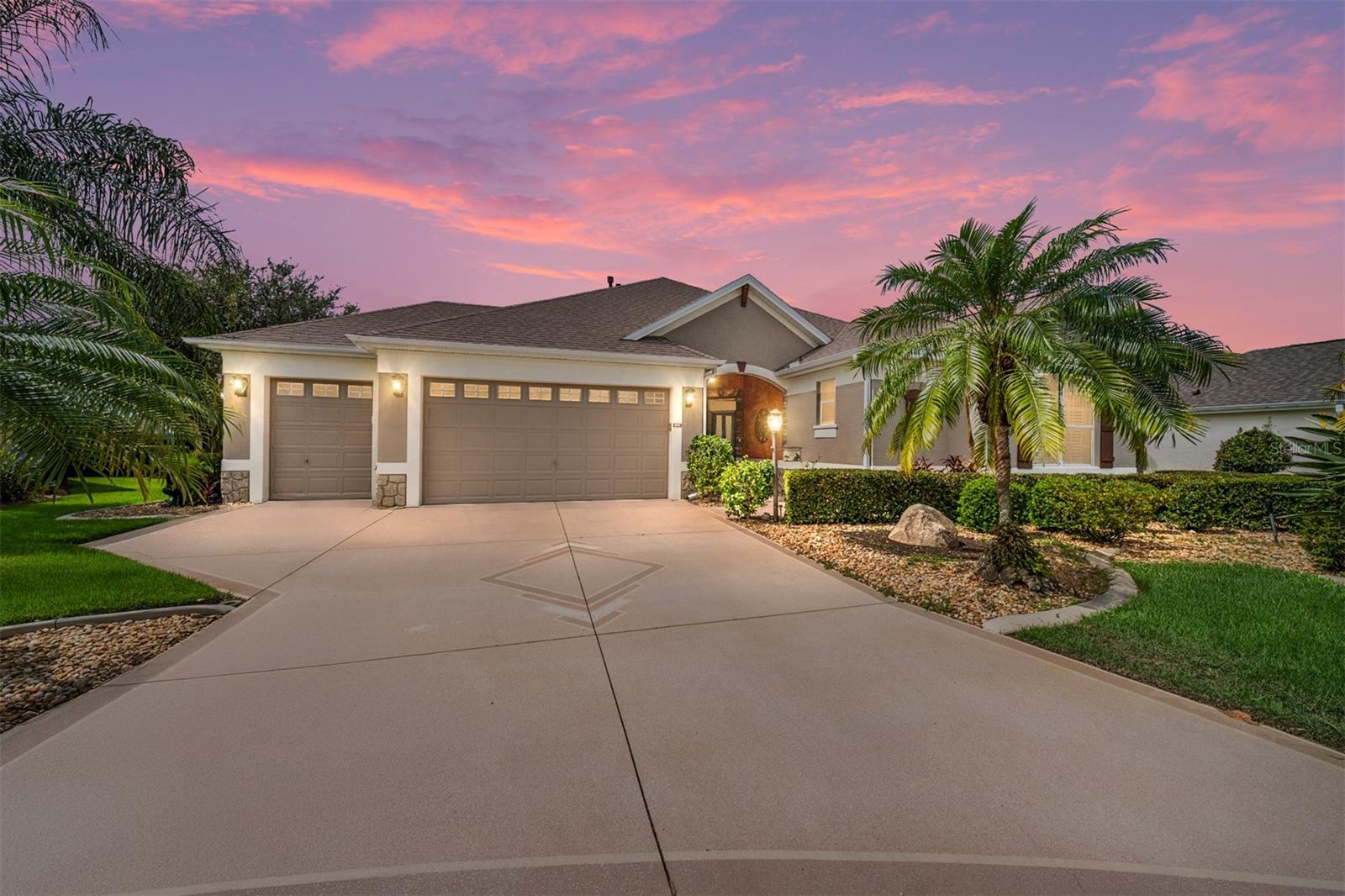 One Owner & Very Well Maintained! Welcome to this stunning Block and Stucco Camden Designer home situated on a quiet cul-de-sac, offering 3 bedrooms, 2 bathrooms, and a 2-car plus golf cart garage in the highly desirable Village of Mallory Square—just minutes from Lake Sumter Landing! As you approach the home, you'll notice the beautiful landscaping and decorative painted driveway and walkway. Inside, an open-concept design features the living and dining areas, complete with LVP flooring, elegant crown molding, and plantation shutters, creating a spacious and inviting atmosphere. The kitchen boasts GRANITE countertops, a TILED backsplash, SS appliances, a built-in pantry, breakfast bar, tile flooring, and cabinetry with pull-outs—ideal for everyday living and entertaining. The primary suite has LVP flooring, a large walk-in closet, and an en-suite bath with double vanities, a tiled walk-in shower, a separate water closet, and tile flooring. The two guest bedrooms and second bathroom are positioned at the front of the home, providing a private guest wing or perfect office space. The second bath features GRANITE countertops, tile flooring, and a tiled tub/shower combo, with a nearby hallway linen closet. Enjoy year-round comfort in the glass-enclosed lanai with a mini-split system, perfect for relaxing or entertaining. Additional features include: ROOF (2023), HVAC (2022), a storage/safe room in the garage, GOLF cart available separately, and a bond of $10,700. Located near Mallory Hill Country Club, championship golf, recreation centers, restaurants, and just a short golf cart ride to Lake Sumter Landing. This beautiful home combines style, comfort, and convenience in one of the most sought-after Villages.