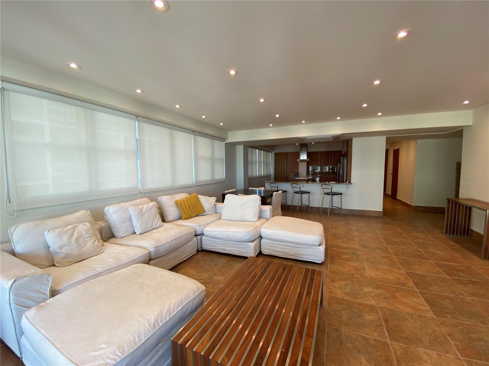 Ideally situated steps from Condado’s finest restaurants, shops, and hotels, this fully furnished home combines comfort with sophistication. Originally a three-bedroom, it has been thoughtfully converted into a spacious two-bedroom layout featuring an oversized primary suite with a custom walk-in closet and a beautifully appointed second bedroom with a leather-framed full bed and custom storage.
The open kitchen is designed for both style and convenience, with granite countertops, a cooking island, breakfast bar, and stainless steel appliances. A bright living area with an office nook extends seamlessly to a private terrace showcasing both city and ocean views.
Additional features include a full backup generator, zoned air conditioning, boutique building setting, and dedicated parking. This property is move-in ready and perfectly suited for refined coastal living in San Juan’s most desirable neighborhood. Available November 1.