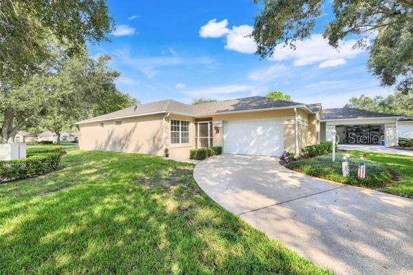 This is a Gardeners dream with beautiful, lush landscaping and vinyl fencing surrounding the property!!! Beautifully upgraded end-unit 2BR/2BA home in the desirable Whitehall section of Kings Ridge, Clermont’s premier 55+ gated golf community. This move-in ready home offers 1,274 sq. ft. with a spacious 1 1/2 car garage. Recent updates include new Kitchen with 42 inch cabinets, luxury porcelain flooring through out, fresh painted , Zano floors in driveway,lanai,front porch and walk way and updated landscaping. Kitchen with pull-out cabinets, modernized baths, and an amazing lanai opening to a private backyard with vinyl fencing and butterfly bushes. Whitehall residents enjoy their own heated pool/tennis plus optional full Kings Ridge amenities. HOA covers lawn, irrigation, cable, internet, exterior paint, & more.