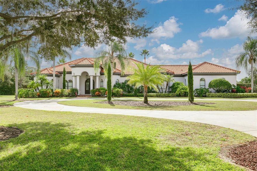 Welcome to a rare opportunity to own in the epitome of elegant living, the prestigious gated community of Keystone Reserve. Nestled at the end of a tranquil cul-de-sac on 1.77 acres, this single-story masterpiece beckons with its grandeur and exclusivity. A long circular driveway adds a touch of sophistication, paving the way to a residence that exudes elegance from every angle. As you approach, 10-ft high arched double doors set the tone for the luxury that awaits within. This home features 5 bedrooms and 4 bathrooms, plus a dedicated office, designed for comfort and versatility. Upon entering, the 12-ft high ceilings create an immediate sense of openness. A spacious sitting area with a gas fireplace offers a panoramic view of the pristine pool, enhanced by engineered hardwood flooring that seamlessly flows throughout, adding warmth to the ambiance. The heart of this home is the gourmet kitchen, a culinary haven with superb Subzero and Viking appliances, a 6-burner gas stove, double dishwashers, custom cabinetry, and Carrera marble counters. A large walk-in pantry adds practicality to the art of cooking and entertaining. Entertain with unparalleled style in the bar/game room, boasting a quartz bar, walnut shelving, wainscoting, and five strategically placed TVs. Movie nights take on new dimensions in the media/movie room, equipped with 7 theater seats, a 120” movie screen, and cutting-edge 4k projection/screen technology. The owner's suite, located in the east wing, is a true retreat. A spacious walk-in closet with a closet system ensures ample storage. The large sitting area with French doors to the pool deck enhances the feeling of luxury. The owner's bathroom is a spa-like haven, boasting granite surfaces, cherrywood cabinets, separate his and her vanities, a cosmetic seating area, travertine flooring, a luxurious microjet spa tub, and an adjoining marble walk-through shower with multi-head rain shower and body sprays. Step into the backyard and explore a 3,200 sqft panoramic screened lanai, showcasing a new state-of-the-art outdoor kitchen with a stylish stacked stone bar. Adorned with a granite countertop and tile backsplash, it’s equipped with a 44-inch four-burner Blaze gas grill featuring a stainless-steel vent hood, double side burner, two-drawer refrigerator, ice maker, pull-out trash bins, sink with hot and cold water, and ample storage. Lush landscaping enhances the outdoor oasis. Whether you prefer unwinding by the heated pool with a raised spa and arch deck jets or relaxing while watching a game, this is Florida living at its finest. The lanai boasts a new fireplace wall, and the outdoor shower with hot and cold water completes this outdoor oasis. Throughout the home, new plantation shutters add a touch of sophistication, highlighting the meticulous attention to detail that defines every aspect of this residence. This is the epitome of luxury living in Keystone Reserve, where every detail has been meticulously curated for the discerning homeowner. Schedule your private tour today and step into a lifestyle of unparalleled refinement.