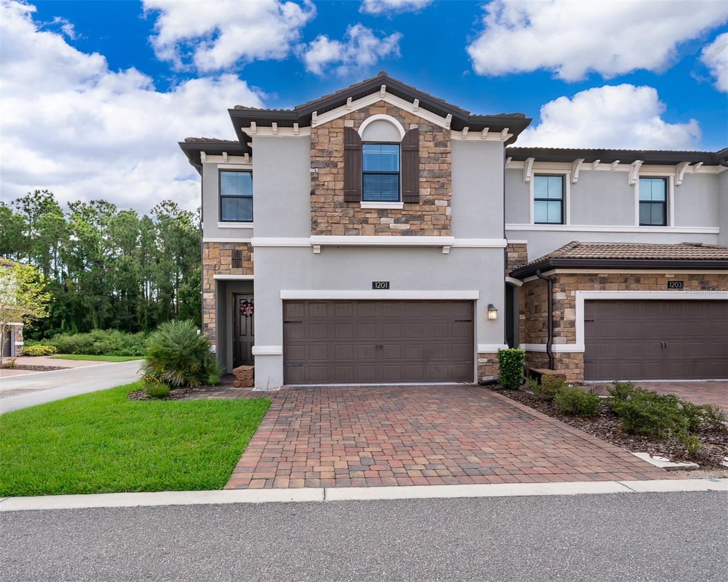 Let this stunning townhome be your next new home in this sought-after ChampionsGate community, nestled near the luxury Omni Champions Gate Hotel that offers fine dining and golfer's paradise! Just minutes from Walt Disney World and Orlando's top attractions, this home features the perfect blend of luxury and convenience. Step inside this barely lived in corner unit home to find tile flooring throughout the lower living area and plush carpeting in the bedrooms. The gourmet kitchen boasts 42" cabinets, quartz countertops, and stainless-steel appliances, making meal prep a delight. Enjoy maintenance-free living with access to world-class amenities, including a resort-style heated pool, fitness room, game room, sauna, golf simulator; also offered are Champions Gate amenities and many golf courses located near to challenge your golfing abilities. Utilities included are internet, basic cable, trash, and exterior pest control. Don't miss the opportunity to live in this prime location near Disney, and everything Magical that Florida has to offer you and your family!
