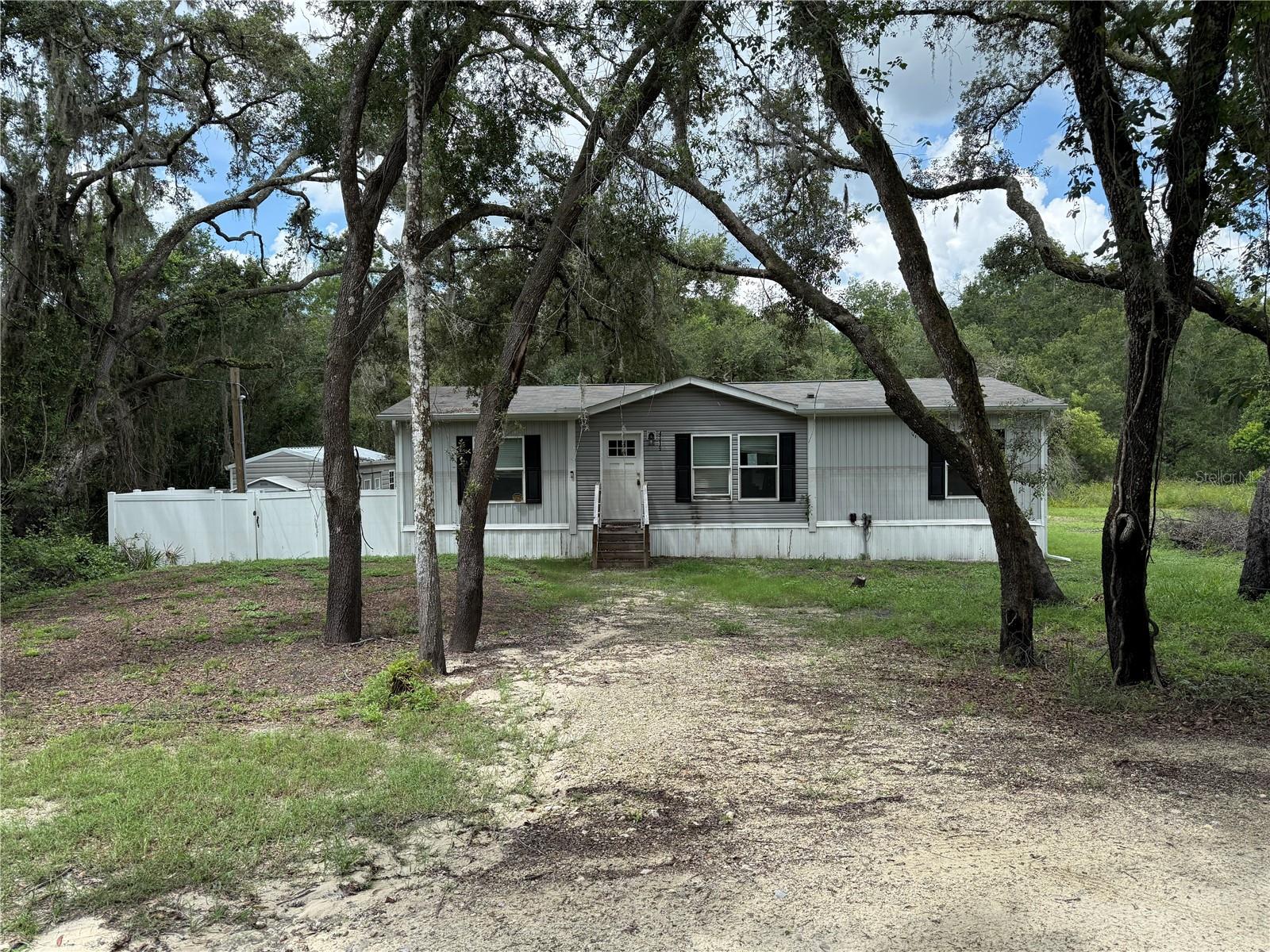 Investor Special: This 2023 3-bedroom, 2-bathroom mobile home is situated on a beautiful corner lot in the heart of Dade City, conveniently located near US 301 and I-75. Nestled in a prime location near major highways for easy commuting access. Electric access, a well, and a septic tank are already in place. Enjoy the tranquility of rural living while still being close to urban amenities, including shopping, dining, and entertainment options. THIS HOME WAS FLOODED DURING THE HURRICANES, PLEASE WEAR A MASK FOR MOLD IS PRESENT!! Schedule a showing today and explore the endless potential awaiting you in Dade City! SOLD AS IS.