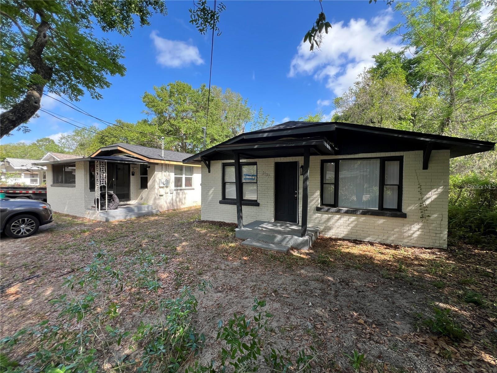 This charming two-bedroom and one-bath home is located on the left of this picture, it is located in Eustis just a short way from the downtown waterfront area!! The home is rented on a month to month basis with current tenant paying $1175 per month. Great ROI !! NEW ROOF! The home offers 665 square feet of renovated living space, blending modern comforts with classic appeal. With its close location to downtown, residents can enjoy easy access to local shops, restaurants, and community events. The home features a brand new permitted roof, updated electric panel, newer flooring, renovated bathroom and kitchen. Inside, you'll find a bright and inviting layout, with freshly painted walls and stylish flooring throughout. The open-concept living area seamlessly connects to the contemporary kitchen, which boasts updated appliances and ample counter space, perfect for cooking. Both bedrooms are comfortable, providing a cozy retreat for relaxation. The bathroom has been tastefully updated with modern fixtures and finishes, enhancing the overall aesthetic of the home. Outside, the property offers a manageable yard, ideal for enjoying Florida’s beautiful weather or for outdoor gatherings. This home is perfect for an investor wanting a turn key rental with over 10% ROI. Owner/Agent! PLEASE NOTE that owner has recently completed a Lot split. Only ONE home exists on this lot and is being offered for sale. Tax records do not reflect lot split at this time, but it has been approved by the City of Eustis and recorded with Lake County. Offer needs Legal Description on attached Survey. Home comes with a transferrable termite bond.