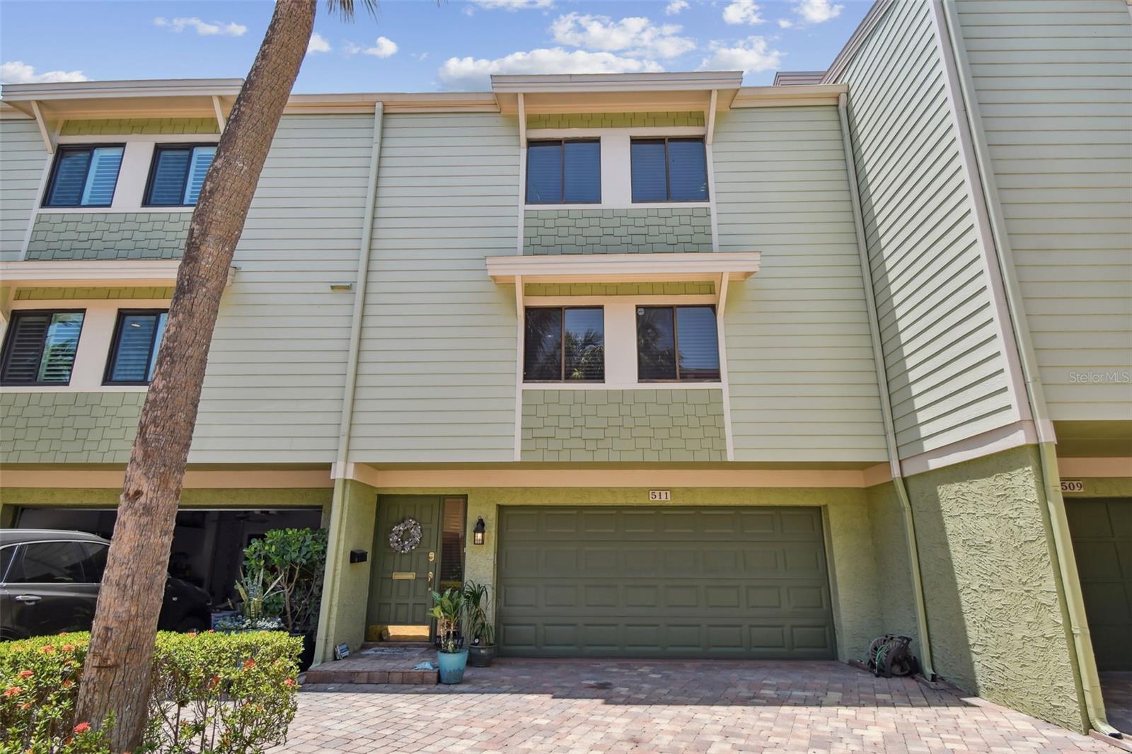 Welcome home to the Village of Paradise Island, a luxury townhome community a mile from the pristine beaches of Treasure Island. This 3-bedroom, 3.5 bath FURNISHED coastal home comes complete with a oversized 2-car garage and a full 2025 sq.ft of living space. The ground level features a new washer and dryer, ample storage and commercial grade rubber flooring perfect for vehicles, golf cart or a home gym. Adjacent to the garage is a finished bonus room with full bathroom and outdoor patio area perfect for grilling and entertaining. The bonus space has epoxy flooring, its own multi AC unit and large closet making it ideal for in-law suite, game room or home office. The second floor main living area is bathed in natural light, showcasing an open floor plan with crown molding, waterproof vinyl flooring and a beautiful stone wall fireplace. Here you'll find the half bathroom, dining area and balcony views. The eat-in kitchen is a chef’s dream, boasting granite countertops, stainless steel appliances, under-counter LED lighting, stylish backsplash, a separate beverage fridge, walk-in pantry, and abundant storage. The upper level is designed for rest and relaxation. Retreat to the oversized primary suite featuring a cedar plank ceiling, spacious walk in closet and private balcony. The en-suite bath features a large walk-in shower and double vanity sink with granite counter tops. A full bathroom and two generously sized bedrooms complete the upper level. This friendly quiet community offers breath taking views of the Gulf of Mexico, two swimming pools, covered gazebos and a fishing pier. Located next door is a public golf course with pickle ball, 8 clay tennis courts and a park. Pack your bags, grab your fishing pole, bikes and kayaks because that's all you'll need. 6-7 month lease availabile, cable/wi-fi/water/pest-control/sewer and trash included.
