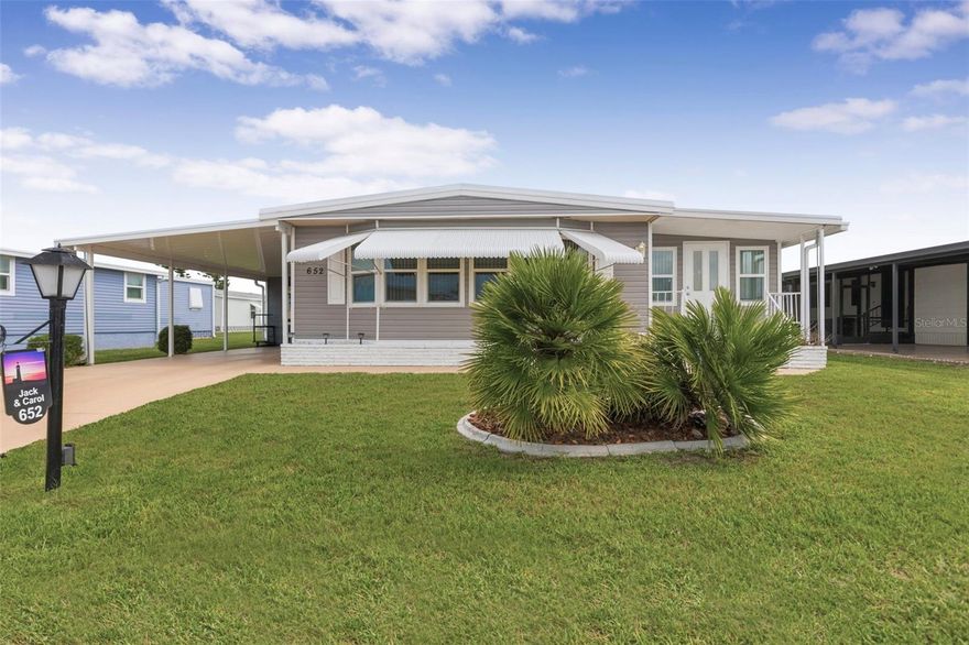 A widened driveway, new carport, roof, and screen room welcome you to this charming two-bedroom, two-bath La Casa home. The entryway includes a double closet and a pantry. The circular kitchen offers plenty of cabinet and counter space, a tiled backsplash, a pantry, a breakfast bar, and a pass-through window to the Florida room. Next to the kitchen, a family room or den opens to a carpeted Florida Room with newer windows, a door to the rear patio, and another to the front walkway. The dining and living rooms combine to create a bright, spacious open area. The dining room has a built-in hutch for extra storage and a perfect place to display your collectibles. The guest bedroom has a large walk-in closet and direct access to the guest bath, which includes a vanity and a tiled tub/shower. The primary bedroom features a double closet, a big walk-in closet, and a pocket door leading to the primary bathroom, which has a double-sink vanity, tile floors, and a roomy Roman shower with a built-in bench for comfort. Many upgrades include a new roof over the home, the Florida room, and the screened lanai. Welcome to La Casa, an enchanting community where 974 home sites are beautifully set among native trees, surrounded by spacious common areas and eight serene lakes. La Casa is perfectly located between Sarasota and Fort Myers. Enjoy easy access to shopping, sightseeing, golfing, and fishing, all while immersing yourself in the rich culture of Southwest Florida.  Experience the warmth of Southwest Florida’s winters in a relaxed environment, far from the east coast hustle. Our lush, mature landscaping reflects the dedicated care of residents and management.  Stay connected with our complimentary Wi-Fi at the Clubhouse, Activity Building, and Recreation Hall while you soak up the sun.  La Casa is a family-friendly haven where you can enjoy tranquility while remaining close to vibrant attractions. Come visit our charming oasis and discover why La Casa is the ultimate destination for snowbirds and year-round residents!