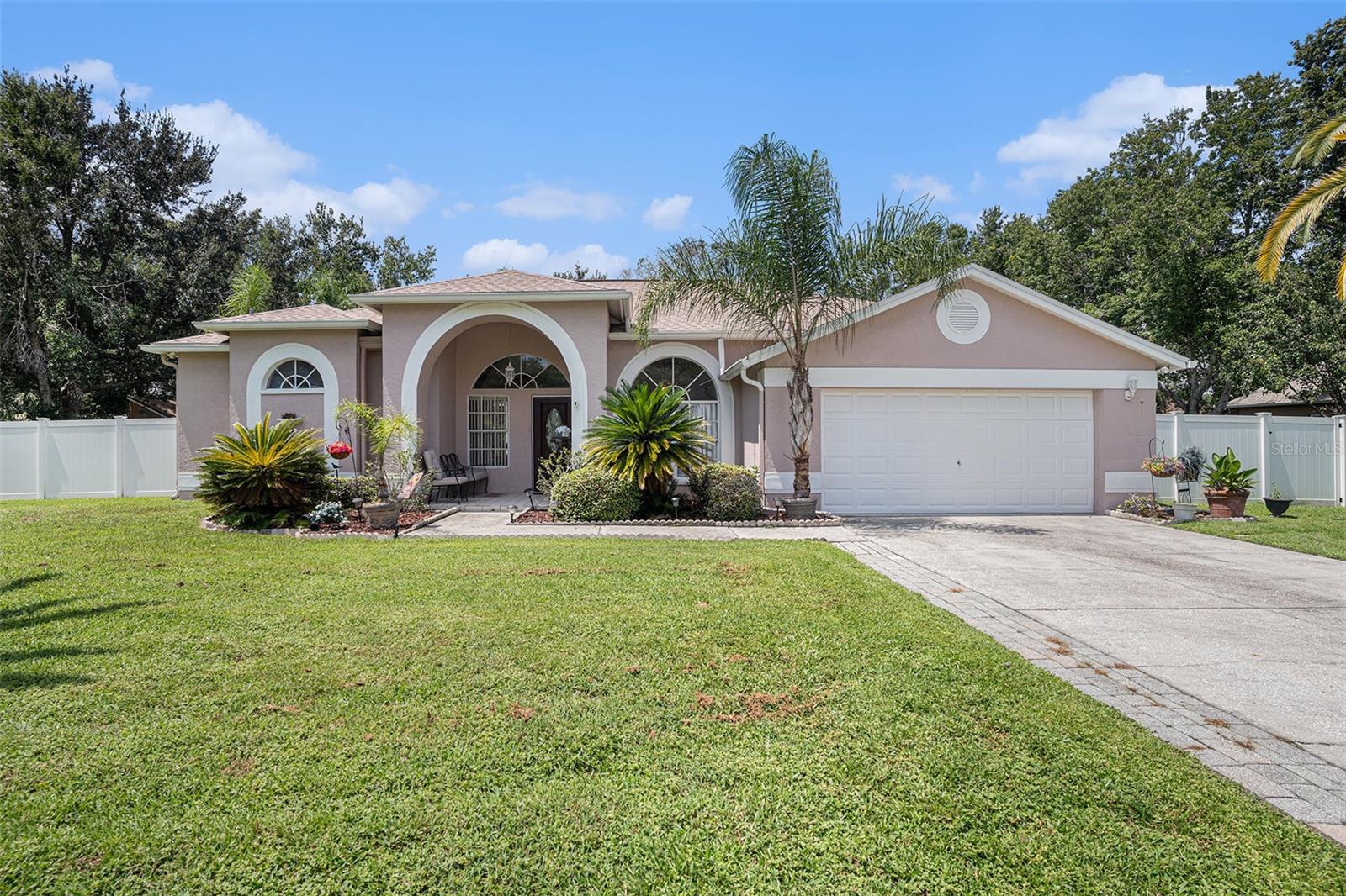 Pool Home on Nearly Half an Acre!! Welcome to this well maintained 3-bedroom, 2-bath home offering the perfect balance of comfort,privacy, and outdoor living. Nestled on almost half an acre, this property is designed for both relaxation and entertaining. Step outside to your own screened-in pool and spa, surrounded by a PVC privacy fence for the ultimate backyard retreat. Inside, the home features a warm and inviting family room with a wood-burning fireplace, a formal dining room for special gatherings, and a formal living room filled with natural light. The kitchen is highlighted with granitecountertops and offers easy flow to the living spaces. The guest bathroom has been thoughtfully updated, while the master suite includes an updatedbathroom complete with a garden tub and separate walk-in shower. Tile and luxury vinyl flooring throughout the home add durability and style. Convenience features include Walk-in His and Her Closets, an inside utility room, a central vacuum system, and an intercom system. The 2-car garage provides plenty of parking and storage, while two additional sheds in the backyard offer even more space for tools, hobbies, or seasonal items. A full sprinkler system helps keep the lawn lush year-round. Located just minutes from shopping, dining, and schools, this home combines spacious indoor living, private outdoor amenities, and everyday convenience.