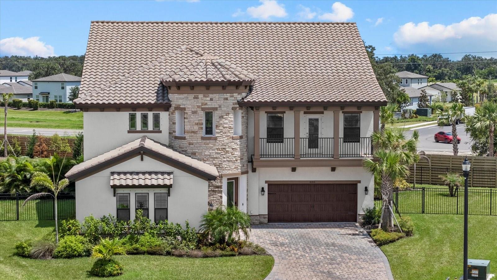 Introducing 8206 Rushton Place—your chance to own a showcase Madeira III home on the largest lot in the sought-after Crosswind Ranch of Parrish. Set at the end of a private cul-de-sac on over a quarter acre, this residence masterfully blends architectural grandeur with modern luxury. Designed to impress from the moment you arrive, the home’s Mediterranean-inspired façade features split garages, stone accents, and a signature rotunda entry that sets the tone for the elegance that follows. Step inside the soaring two-story foyer, where the angled staircase and natural light create a breathtaking welcome. The formal dining room and office with custom built-ins anchor the entrance, offering well-appointed spaces for entertaining and productivity. Throughout the home, refined details like crown molding elevate the overall design and add timeless character. The heart of the home is the expansive gourmet kitchen—an entertainer’s dream—featuring rich quartz countertops, built-in wall oven with a microwave above, gas cooktop, custom mosaic backsplash, and a large island that gracefully transitions into a built-in dining table. The great room flows effortlessly into the screened lanai through expansive sliders with electric shades, revealing a 2024 resort-style pool with triple waterfalls, built-in spa, sun shelf with in-water loungers, and Italian marble decking beneath a soaring two-story screen enclosure. Downstairs, a guest suite with a full bath doubles as a convenient pool bath, while a stylish powder room completes the main level. Durable yet elegant, luxury vinyl plank flooring extends throughout the first floor, enhancing the home’s inviting ambiance. Upstairs, discover a versatile loft with wet bar, three oversized secondary bedrooms—including two that share a Jack-and-Jill bathroom—and a custom laundry room with built-in cabinetry, quartz counters, a utility sink, folding counter, and drying bar for added functionality. The primary suite is a serene retreat with dual walk-in closets, a spa-inspired bathroom featuring marble counters, dual vanities, a soaking tub, and a walk-in shower. Step out onto the full-length private balcony for tranquil views of your tropical oasis—an ideal space for morning coffee or evening relaxation. Additional highlights include a whole-house water filtration system, reverse osmosis in the kitchen and wet bar, and a spacious 3-car garage. As a resident of Crosswind Ranch, you’ll enjoy access to premier amenities including a lagoon-style pool and cabana, dog park, pickleball courts, and scenic walking trails. Ideally situated just 3 miles from Publix and all the vibrant shopping and dining options in North River Ranch, 2.5 miles to the brand-new Parrish Community Park, 3 miles to Parrish Community High School, and only 7 miles to I-75 with easy access to I-275 and the stunning Gulf Coast beaches—this home offers both luxury and location. Why wait for new construction when you can own this impeccably designed and upgraded Madeira III—where every detail has been curated for comfort, elegance, and enduring value? Welcome home to 8206 Rushton Place, Parrish!