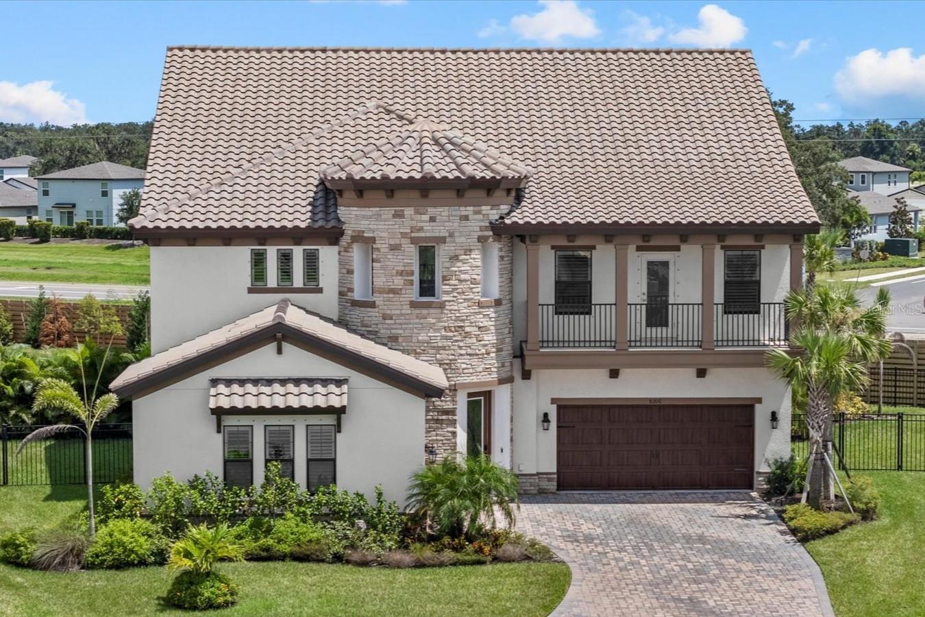 Introducing 8206 Rushton Place—your chance to own a showcase Madeira III home on the largest lot in the sought-after Crosswind Ranch of Parrish. Set at the end of a private cul-de-sac on over a quarter acre, this residence masterfully blends architectural grandeur with modern luxury. Designed to impress from the moment you arrive, the home’s Mediterranean-inspired façade features split garages, stone accents, and a signature rotunda entry that sets the tone for the elegance that follows. Step inside the soaring two-story foyer, where the angled staircase and natural light create a breathtaking welcome. The formal dining room and office with custom built-ins anchor the entrance, offering well-appointed spaces for entertaining and productivity. Throughout the home, refined details like crown molding elevate the overall design and add timeless character. The heart of the home is the expansive gourmet kitchen—an entertainer’s dream—featuring rich quartz countertops, built-in wall oven with a microwave above, gas cooktop, custom mosaic backsplash, and a large island that gracefully transitions into a built-in dining table. The great room flows effortlessly into the screened lanai through expansive sliders with electric shades, revealing a 2024 resort-style pool with triple waterfalls, built-in spa, sun shelf with in-water loungers, and Italian marble decking beneath a soaring two-story screen enclosure. Downstairs, a guest suite with a full bath doubles as a convenient pool bath, while a stylish powder room completes the main level. Durable yet elegant, luxury vinyl plank flooring extends throughout the first floor, enhancing the home’s inviting ambiance. Upstairs, discover a versatile loft with wet bar, three oversized secondary bedrooms—including two that share a Jack-and-Jill bathroom—and a custom laundry room with built-in cabinetry, quartz counters, a utility sink, folding counter, and drying bar for added functionality. The primary suite is a serene retreat with dual walk-in closets, a spa-inspired bathroom featuring quartz counters, dual vanities, a soaking tub, and a walk-in shower. Step out onto the full-length private balcony for tranquil views of your tropical oasis—an ideal space for morning coffee or evening relaxation. Additional highlights include a whole-house water filtration system, reverse osmosis in the kitchen and wet bar, and a spacious 3-car garage. As a resident of Crosswind Ranch, you’ll enjoy access to premier amenities including a lagoon-style pool and cabana, dog park, pickleball courts, and scenic walking trails. Ideally situated just 3 miles from Publix and all the vibrant shopping and dining options in North River Ranch, 2.5 miles to the brand-new Parrish Community Park, 3 miles to Parrish Community High School, and only 7 miles to I-75 with easy access to I-275 and the stunning Gulf Coast beaches—this home offers both luxury and location. Why wait for new construction when you can own this impeccably designed and upgraded Madeira III—where every detail has been curated for comfort, elegance, and enduring value? Welcome home to 8206 Rushton Place, Parrish!