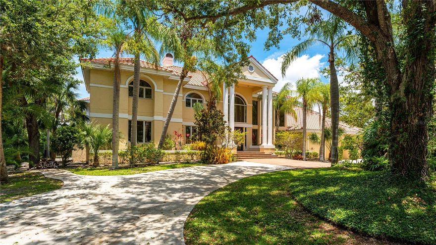 Perfectly situated on a quiet cul-de-sac in The Landings, this exquisite home boasts over 8,000 square feet of living space. Mature landscaping surrounds the property creating privacy and a sense of relaxation. Upon entering the foyer, beautiful marble floors and a dramatic curved staircase welcome you into the home. The living room offers a formal yet intimate space with a wood burning fireplace and french doors leading to the outdoor gathering area. The newly renovated kitchen is well appointed with quartz countertops, farmhouse sink and luxury appliances including a professional range and built-in refrigerator and freezer. The first floor offers a private study/den as well as a beautiful guest suite with private access to the backyard living area. Recently renovated oversized pool and spa elevates the indoor/outdoor Florida living experience. The home includes two additional wood burning fireplaces which create inviting and intimate spaces. The oversized primary suite opens to an upstairs veranda overlooking the pool and private surroundings. Three additional bedrooms boast oversized closets and flex space. A separate living area/media room completes the second floor. The Landings is an exceptional gated community centrally located west of trail with A-rated schools, easy access to downtown Sarasota and a 5 minute drive to Siesta Key.