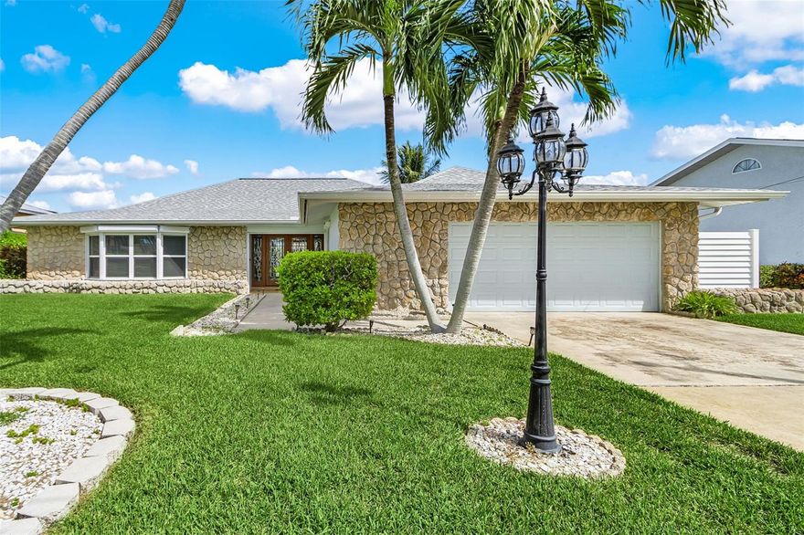 A Boater's Paradise: Sailboat Access on the Caloosahatchee River
Step into the extraordinary with this meticulously maintained and thoughtfully designed 4-bedroom, 2-bathroom ranch-style masterpiece offering 2,930 square feet equipped with an oversized 2 car garage offering tons of prime living space on the Caloosahatchee River. From the moment you approach the stunning glass double door entryway, you'll know you've found something special. Set on almost a quarter of an acre, this property is a true boater's dream with deep water, sailboat access and a short 20-minute boat ride to the Gulf.
Exceptional Waterfront Living. The boater's amenities are unparalleled: the dock has been redone and refinished with 80 feet of water frontage, complete with electric and water hookups. A large 10,000 LBS boat lift and an expansive deck spanning almost the length of the home ensure you have the perfect spot for sunbathing and easy access to the water. Inside, the home boasts brand new carpet installed throughout and begins with a huge formal living space attached to an eloquent formal dining area. The home is built for peace of mind, featuring a whole home 22W generator, great for added peace of mind, electric storm shutters for added protection and lowering insurnace costs, a new hot water heater, and a 4-year-old roof with all the engineered upgrades.
Gourmet Kitchen and Tranquil Retreats. The chef's dream kitchen is an entertainer's delight, featuring tons of cabinets and storage, solid surface countertops, a gas range, upgraded appliances, a built-in oven and microwave, a breakfast bar, and a cozy eat-in kitchen dining space.
The kitchen flows effortlessly into a back family room, a tranquil space with stunning water views and an electric fireplace for a warm, cozy feel. Walk out from here onto the amazing covered patio, which screams sophistication with ample outdoor dining space to enjoy your morning coffee or a relaxing dinner while overlooking nature and the pristine river.
Luxurious Bedrooms. The spacious master bedroom is a true retreat, offering breathtaking water views, a large walk-in closet, and its own elegant en suite bathroom with a beautiful vanity and a large walk-in shower. The other perks of this stunning home features three large guest bedrooms, all with walk-in closets, and sharing a beautifully updated bathroom with a tub and shower combination. One of these guest rooms is well appointed and feels like a hotel room that has stunning wood French doors that lead directly out to the patio, capturing those spectacular water views that surround this rare property. Offering an array of modern updates, an exceptional outdoor living space, and a prime location, this magnificent waterfront property is a stunning masterpiece and an opportunity not to be passed on.
Ready to step aboard your new waterfront lifestyle?