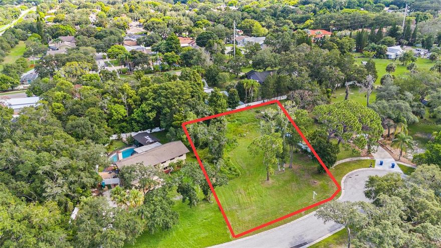 Welcome to this exceptional 1/2-acre vacant lot, perfectly positioned in a peaceful cul-de-sac within Spanish Woods of Palm Harbor. This prime piece of real estate is a rare find, offering the ideal setting to build your dream home. The property is situated at an elevation of 37’ above sea level and is NOT located in a flood zone! Surrounded by lush greenery and mature trees, this lot provides a serene and private environment. The property is located at the end of a quiet, no-outlet paved street, ensuring minimal traffic and a tranquil living experience. The lot is spacious and well-defined, offering ample space for a variety of home designs and outdoor living possibilities. Enjoy the convenience of being just minutes away from some of the area's best attractions. Walk, jog, or bike to the stunning Honeymoon Beach, Caladesi Island, and the Pinellas Trails. A short 5-10 minute drive will take you to the vibrant downtown Dunedin, known for its charming shops and restaurants. Additionally, you are just 15-20 minutes away from Clearwater Beach, the Tarpon Springs Sponge Docks, and Howard Park. This beautiful property is close to shopping, fine dining, golfing, marinas, and the Mease Countryside Hospital. It is also located within an area served by A-rated Palm Harbor schools. Utilities, including water and sewer, are readily available at the street, and with no HOA, you have the freedom to design and build your home to your exact specifications. The location offers excellent connectivity, with Tampa and St. Pete airports just 25-30 minutes away. This is a fantastic opportunity to create your own haven in a prime Palm Harbor location. Don’t miss out on this exceptional property!