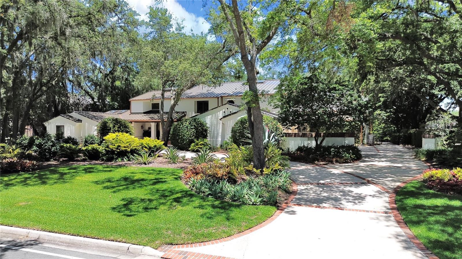 Located in Tampa Bay’s premiere Golf and Country Club community, this gorgeous custom home has been remodeled extensively and boasts a BRAND NEW GORGEOUS METAL ROOF! This home literally has it all! Never has 7500+ square feet felt this warm and comfortable. As soon as you walk into this home, you’ll be wowed by the volume ceilings, open floor plan and the stunning oversized porcelain floor tile. An abundance of natural light shows off the incredible wood beams and ceiling trim throughout this most beautiful indoor living space. So many places to spread out- including an entertainment area with a well equipped bar and plenty of room for a pool table. You’ll certainly appreciate the separate media room/home gym/bonus room and two home offices (one is currently being used as an art room). The gorgeous black walnut floors lead you upstairs to four bedrooms - all with own private bathrooms. The expansive master suite features a lovely sitting area and long balcony with gorgeous views of the pool and golf course. Want more?! How about a gorgeous outdoor living area…a 4+ car garage…amazing golf course views?! There is not enough space to list all the incredible features of this home. Please click on the Virtual Tour to see additional details!