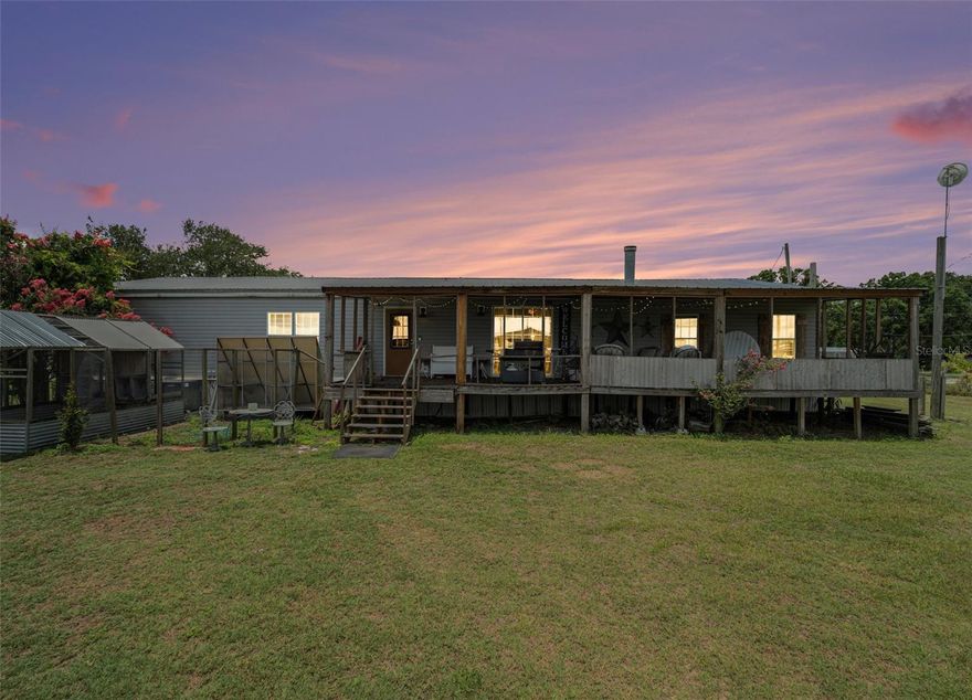 Welcome to your serene retreat nestled on nearly 1 acre of expansive property! This charming 3-bedroom, 3-bathroom manufactured home also features a dedicated office that could easily serve as a fourth bedroom—offering the perfect blend of comfort and outdoor paradise. Inside, you'll find a spacious layout with all bedrooms featuring walk-in closets—providing ample storage and personal space for everyone in the household. The heart of the home is a warm and inviting farmhouse kitchen, featuring plenty of cabinet space, custom countertops, a stylish backsplash, a large island perfect for meal prep or casual dining, and a farmhouse sink that adds charm and functionality. Step outside to discover a large pole barn with 3 stalls—ideal for housing horses, goats, or other animals, or for use as extra storage or a workshop. The detached covered entertainment patio is perfect for hosting outdoor gatherings, movie nights, or simply relaxing while watching stunning sunsets. Additional highlights include two powered storage sheds—great for tools, equipment, or creative projects. You'll also find a chicken coop in good shape and ready for your feathered friends. Just a bit of TLC and both will be ready to go! Whether you're dreaming of hobby farming, entertaining under the stars, or enjoying the peace and privacy of country living, this property offers endless possibilities. Don’t miss your chance to turn this versatile space into your perfect home!