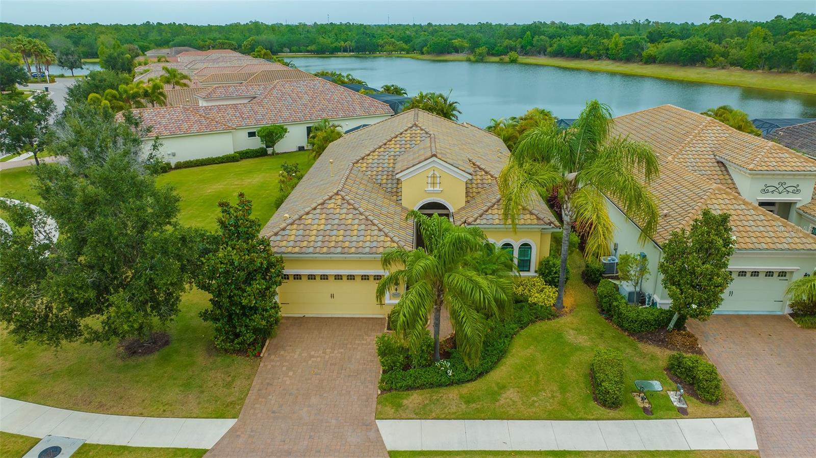 Enjoy maintenance-free living and stunning views on an oversized homesite in Country Club East’s Highlands neighborhood. With nearly 2800 sq.ft. of well-appointed space, enjoy three beds, two and one-half baths, office, and private pool. With architectural details throughout, this spacious Viano Del Mar floor plan features volume ceilings, an extra-wide entryway, dining room and 19 x 21 great room with sliders to screened-in covered lanai and private pool. Kitchen offers granite counters, breakfast bar, stainless appliances, pantry and dinette area with aquarium window. Primary suite is a peaceful retreat with double door entry, bay window sitting area, soaking tub, walk-in shower, dual vanities, two walk-in closets, and private water closet. Two guest rooms are set privately and office has wood floors and French door entry. Special features include huge yard, access to pool bath from lanai, utility sink in laundry room, crown moldings, plantation shutters, paver lanai and drive, tile roof, and so much more… Country Club East offers gated security, three resort pools, including the retreat aquatic center, fitness center and club room with billiards. Lakewood Ranch is the number one best-selling, multigenerational community in the country and located near world-class shopping, dining, entertainment of Lakewood Main Street, University Town Center, downtown Sarasota and is minutes to I-75, beaches, great schools and medical facilities.