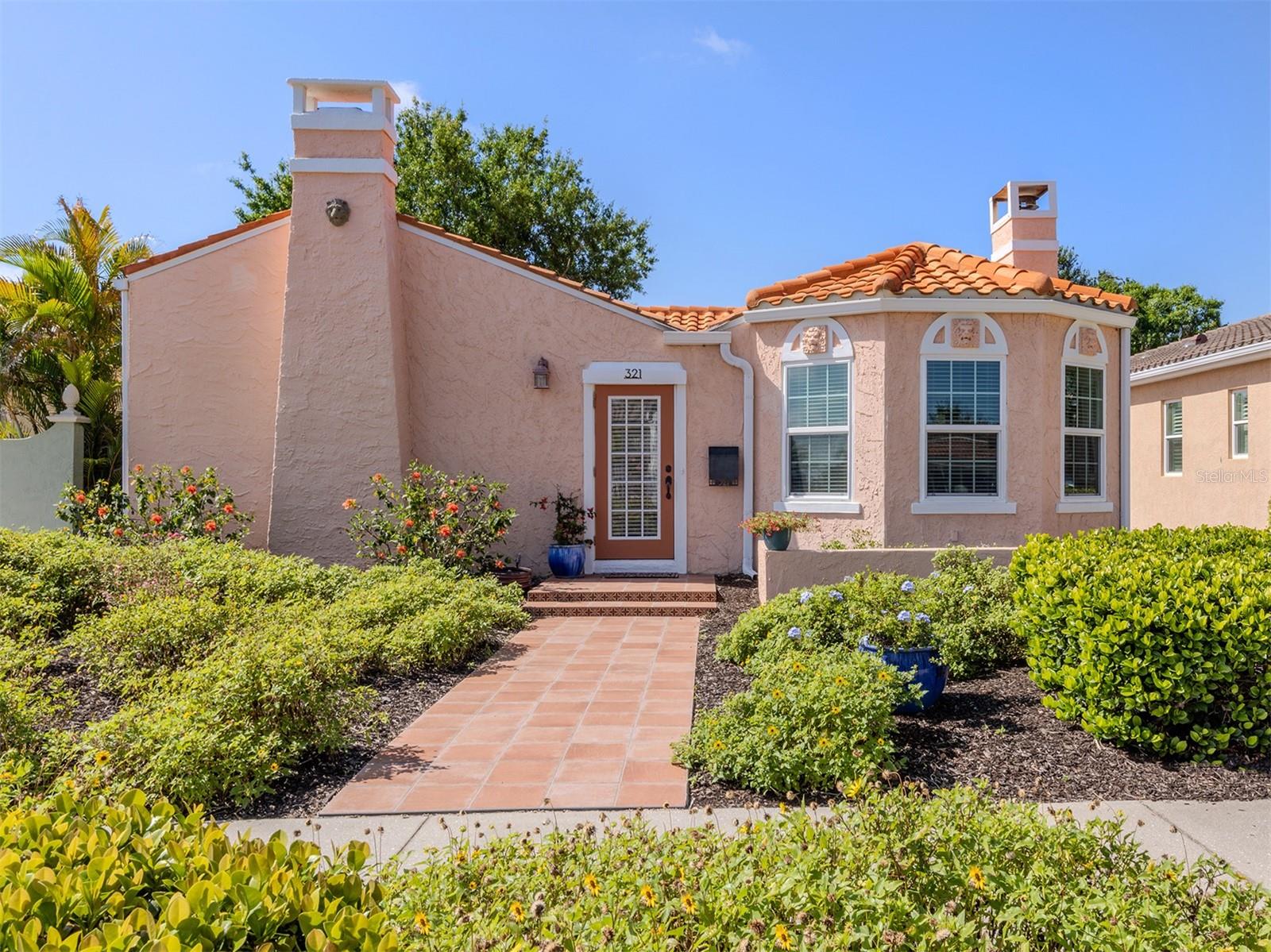 One of Venice Island's most charming homes on one of its nicest blocks. This 1926 Mediterranean gem was tastefully updated, is just two blocks to Venice Avenue shops and restaurants and six blocks to the beach. The main house boasts a split bedroom design of three bedrooms, two full baths, with period details throughout including original fireplace, refinished hardwood floors, arched doorways and built-in display shelves. Near the entrance, across from the living room, French doors open to the primary bedroom, one that is filled with light and offering a cozy sitting area with fireplace and a renovated en-suite bath. The large updated kitchen provides great cabinet space, granite counters, stainless appliances and easy access to the formal dining room. Through French doors in the third bedroom being used as an office, enter the large fenced yard providing privacy for your 7-foot-deep heated swimming pool, a great place to enjoy a quiet moment with a good book or entertain family and friends. Beautiful Florida plants and shrubs and an outdoor hot and cold shower complete this heavenly picture of comfort. Your guests will love the standalone pool house with a private entrance featuring a small kitchen, bath, laundry, and a large and beautifully appointed guest suite with hardwood floors and wrought iron railings. Turn this versatile space filled with sunshine into your art studio, gym, yoga, game room, in-law or kid's suite. The possibilities are yours. Additional important features include impact-resistant windows throughout and solar panels that help with energy costs. Schedule your private appointment today and fulfill your beach-town dreams in this historic beauty in the heart of Venice Island!