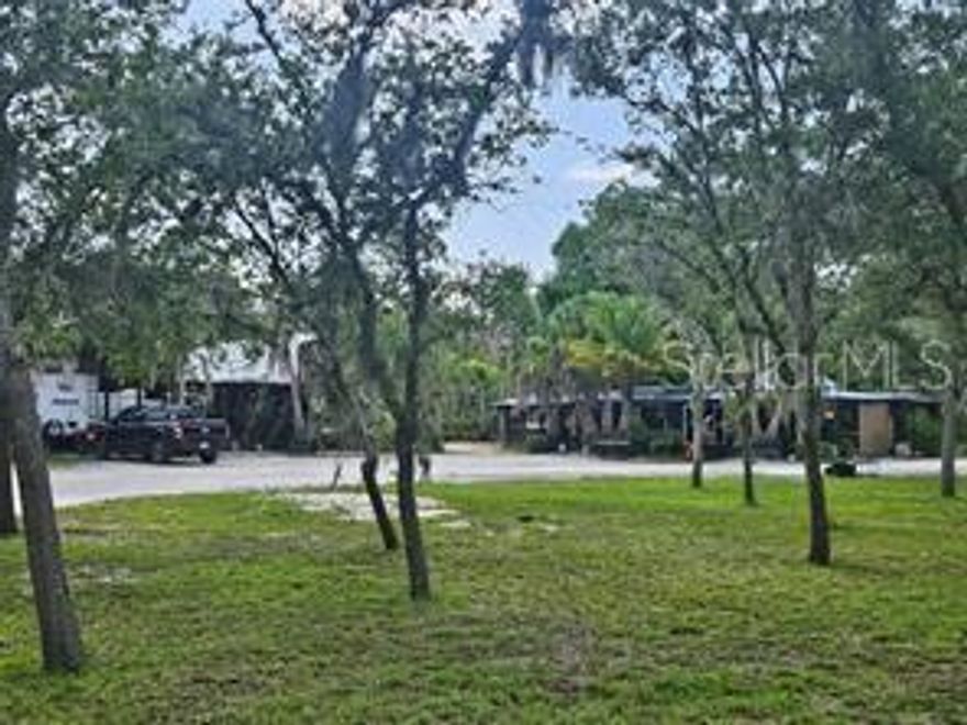 5 acres of high and dry, impacted land. With over 300 manacured fruit and palm trees. 2 electrical boxes have been impacted on site, 3 RV pads, 2 septic systems, well water system, the list of trees on site include figs, mangos, avocados, Lemons, limes, keylimes, oranges, tangerines, pomelo, jackfruit, starfruit, persimmons, pomegranates, bananas, dragon fruit, loquat, papayas, peaches, plums, cherries, guava, blackberries, palm trees, limquat, and kumquat. Property is high and dry. This property is an oasis and is easy to access. 5 acres of pristine manacured cleared land with fruit, palms, RV pads, septic systems, and electic.