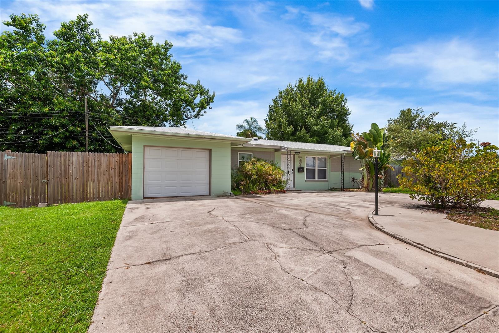 This charming home in St Petersburg’s desirable Meadowlawn neighborhood offers an unbeatable price and incredible potential, just minutes from downtown St Petersburg, America’s best beaches, downtown Tampa, and countless attractions. While it could use a little TLC, the property boasts a screened-in lanai with a sparkling pool, perfect for relaxing or entertaining, overlooking a spacious fenced-in backyard with serene pond views. Inside, gleaming terrazzo flooring flows throughout, adding timeless character. The primary suite is a true retreat, featuring sliding glass doors that open directly to the pool and lanai, plus a renovated bathroom with an oversized walk-in shower. The kitchen shines with elegant granite stone counters and classic shaker cabinets. Outside, a convenient circle drive provides ample parking, complemented by a one-car garage that also houses a washer and dryer for added convenience. Don’t miss this opportunity to own a slice of paradise in a prime location, ready for your personal touch.