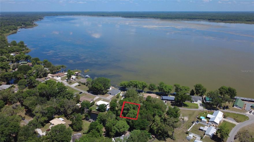 Discover the potential of this beautiful lot located in a quiet area in Lake Panasoffkee. This property features a lake view with a canal in the rear, offering a peaceful setting with added privacy and natural charm. It presents an excellent opportunity to build your dream home, invest in land, or create a private getaway surrounded by natural Florida beauty.

Just around the corner, you’ll find Big Bass Grill, offering both indoor and outdoor dining—perfect for enjoying great food, live music, and scenic lake views. Nearby, Big Cypress Lakefront Italian Pizzeria provides a relaxing waterfront atmosphere with classic Italian cuisine.
Enjoy small-town charm while being just minutes from The Villages, known for its free nightly entertainment, golf courses, shopping, dining, and more. You’re also within reach of Florida’s west coast, where you can explore waterfront dining, kayaking, fishing, beaches, and natural springs—perfect for weekend adventures.

With convenient access to I-75 and the Florida Turnpike, travel to Orlando’s theme parks and major airports is easy. Whether you’re looking to build now or hold for the future, this property is full of possibilities.
Equal Housing Opportunity.