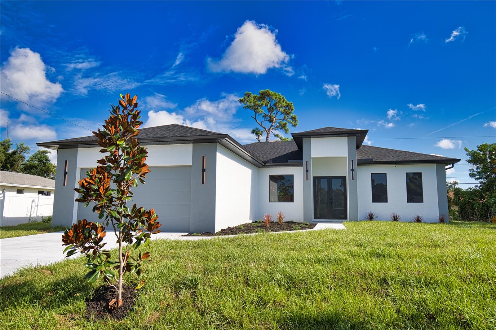 This GREAT VALUE, new-construction 3/2 home provides a modern and peaceful living space in the thriving community of SOUTH VENICE. The NO-HOA, NO FLOOD ZONE, 1 YEAR BUILDER'S WARRANTY and LOCATION make this home a real find! As a SOUTH VENICE resident, you can take advantage of the SOUTH VENICE BEACH FERRY, transporting you to your own PRIVATE BEACH on Manasota Key and gain access to the resident BOAT LAUNCH. This serene neighborhood is close to so many unique activities such as several nature parks, Legacy Trail, Historic Downtown Venice, Warm Mineral Springs, Venice Fishing Pier and is a 6 minute drive to Manasota Beach, a 15 minute drive Venice beach! The home's exterior is welcoming and stylish with modern lighting and landscaping along with the peace of mind of hurricane impact windows and a high elevation. The open floor plan allows you to enjoy the main living areas simultaneously. The living room, dining area, and kitchen flow together perfectly, providing the ideal space for entertaining or family gatherings. The HIGH TRAY CEILINGS, ceiling fan and large windows flood the main area with natural light and create a cheerful and inviting atmosphere. The neutral color palate allows you to add your personal touches and customize your look. The heart of this home is the sleek, modern kitchen. The quartz countertop and breakfast bar are perfect for casual dining and gathering. Soft close cabinets with gola profile and drawers with a modern, stylish and clean look. Stainless steel appliances, ample cabinet storage space and pantry complete the wish list for a perfect kitchen. The spacious dining area is designed for serving family meals or entertaining and includes upgraded lighting that contributes to this home's unique charm. Sliding glass doors provide access to the SPACIOUS LANAI off the main living area creating a seamless transition from indoor to outdoor living space. The master suite is a TRANQUIL RETREAT elevated by gorgeous tray ceiling, ceiling fan and sliding door to back yard. The en-suite bathroom feels like a PRIVATE SPA with a gorgeous OVERSIZED SHOWER, rain shower head, upgraded LED mirrors and soft LED lighting under the vanity to provide you a PEACEFUL HAVEN. 3 additional bedrooms with ample closet space and ceiling fans share a well-designed bathroom with a tub and the same upgraded rain shower head, LED mirrors and LED lighting. Laundry will be less of a chore in this spacious and neat laundry room featuring a convenient utility sink and cabinet. The 2 car garage conveniently leads to the laundry room for the perfect transition and kick off your shoes upon your arrival home! This property is staged and easy to show! It's features, proximity to beaches, unique outdoor/shopping make this house the ideal place to call home.