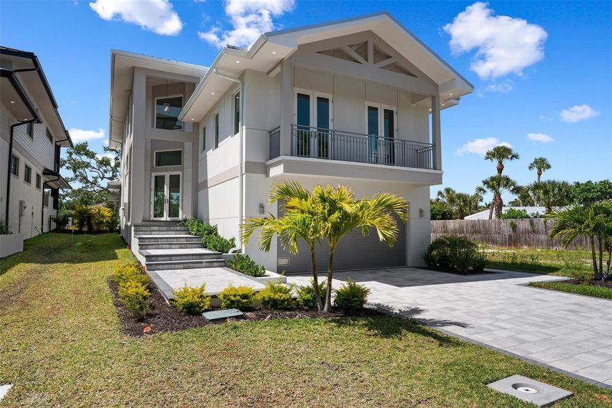 Under Construction. New Construction.  This stunning new waterfront home is perfectly positioned on Siesta Key’s Grand Canal, offering excellent boating water with quick access to Sarasota Bay. The residence features 4 bedrooms, 5 full baths (including a pool bath), and 1 half bath, along with two laundry rooms conveniently located on the first and third floors. A spacious third-floor loft provides a versatile living area just before entering the primary suite, ideal for a lounge, office, or private retreat. The open-concept family room and dining area showcase a Thermador-equipped kitchen and overlook a spectacular outdoor living space with an outdoor kitchen, pool with sun shelf, and custom deck leading directly to your private dock. Two balconies—one at the front of the home and one with sweeping waterfront views—enhance the indoor-outdoor lifestyle. Custom cabinetry throughout, quartzite countertops, and high-quality construction reflect attention to detail at every turn. Located just minutes from Siesta Key Beach, Siesta Village, and all of Sarasota’s amenities, this exceptional waterfront home is a rare opportunity—come see it for yourself.