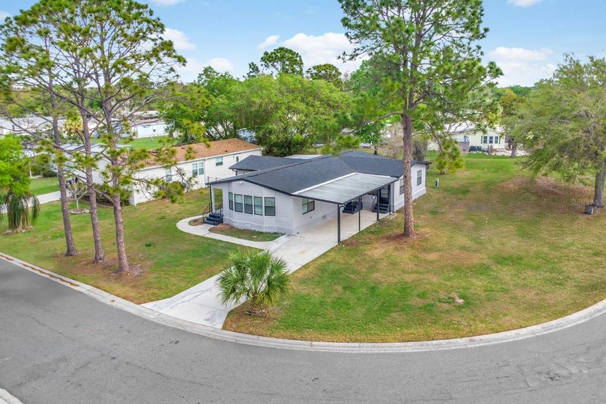 Beautifully updated 4-bedroom, 2.5-bath home situated on a spacious corner lot with an extended driveway and covered carport. This move-in-ready home features a bright open floorplan with bay windows that bring in natural light. Major updates include a new roof and fresh interior and exterior paint, with the AC serviced in March 2026. The fully renovated kitchen includes new stainless steel appliances, quartz countertops, solid wood white shaker cabinets, built-in trash can and lazy susan, a slide-in range with island range hood, and a microwave conveniently located in the pantry. New luxury vinyl plank flooring, blinds, faucets, lighting, fans, toilets, baseboards, and interior doors have been installed throughout the home. The primary suite features a spa-like bathroom with a freestanding soaking tub with a separate walk-in shower and dual vanity. A Jack-and-Jill bathroom connects two additional bedrooms, and the interior laundry closet adds everyday convenience.  The home features 185 sqft of storage with its own entrance at the rear of the home. Located in a community with low HOA fees that include lawn care and internet with NO lot fees. Residents also enjoy access to a community pool, tennis courts, basketball courts and shuffleboard. This home offers updated features, functional living space, and a desirable location. Conveniently located to shopping, schools, restaurants and major highways.