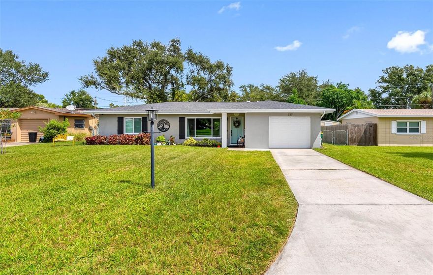 Situated in the desirable BELLEAIR BLUFFS community, this beautifully remodeled home offers 1,352 square feet of modern living space with a one-car garage. Now available at a NEW PRICE, this residence is surrounded by well-kept, upgraded homes in one of the area’s most peaceful and established neighborhoods.
Just two blocks from the Intracoastal Waterway, the home sits high and dry in NON-FLOOD ZONE X and outside any evacuation zone. Updated with quality finishes throughout, the kitchen was completely redesigned in 2022 with quartz countertops, a custom stone backsplash, stainless steel appliances, and a farm sink. A built-in coffee system with filtered water adds a touch of luxury. Continuous wood-style flooring, smooth ceilings, and recessed lighting enhance the living areas, while the Florida room provides flexible space for an office or possible third bedroom.
Recent upgrades include a new roof and exterior paint (2022), hurricane-rated windows and doors, updated electrical throughout, solar attic fans, and a new garage door. The HVAC system was replaced in 2018 and features a smart thermostat. Plumbing has been professionally scoped and fitted with two cleanouts, providing peace of mind and easier maintenance in this mid-century home. Additional features include a Ring doorbell with three cameras, washer and dryer (2021), modern fixtures and fans, and remodeled bathrooms with marble vanities and tiled showers.
The backyard is designed for FLORIDA LIVING, offering space for dining and entertaining, a fire pit, mature landscaping, and a large storage shed. A 220 line remains from a previous hot tub, making it easy to add a spa if desired.
Conveniently located near Mildred Helms Elementary, the Pinellas Trail, boutique shops, and local restaurants, this home is also just minutes from the Pelican Golf Club, Belleair Country Club, and award-winning Gulf beaches. This Belleair Bluffs residence combines thoughtful design, modern updates, and a quiet neighborhood setting—an exceptional find in one of Pinellas County’s most sought-after communities.