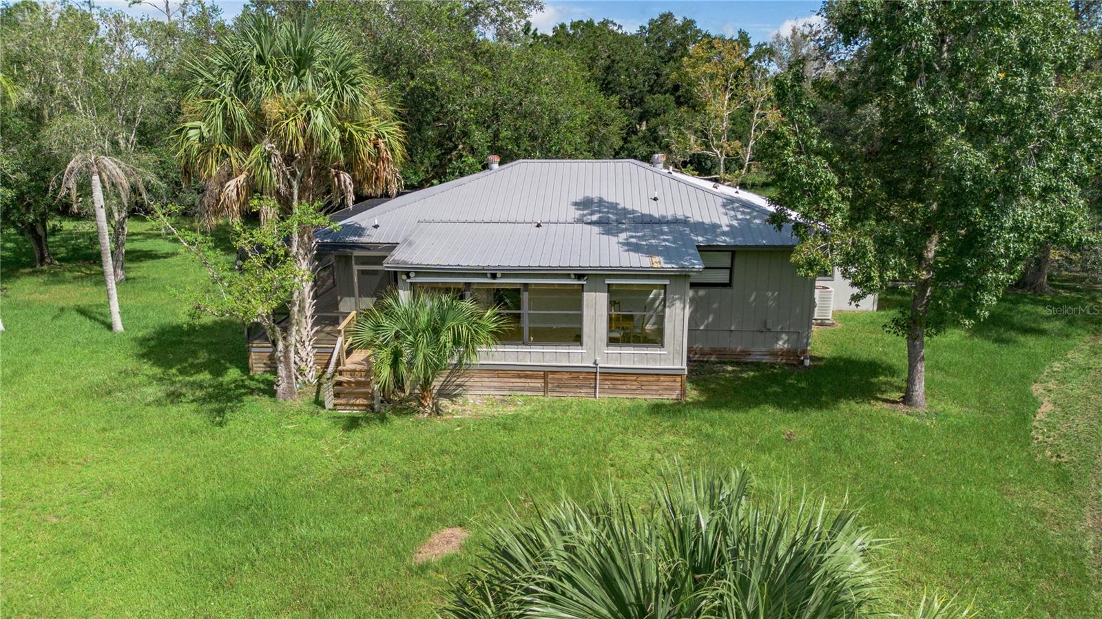 Live Where Nature Meets Elegance
Charming Florida Cracker Home in Indian Hammock Hunt & Riding Club
Escape to your own private retreat on 3 secluded, partially fenced acres in the elite, gated community of Indian Hammock. This beautifully crafted 3-bedroom, 3-bath Florida Cracker-style home blends timeless design with modern comforts — the perfect balance of rustic charm and refined living.
Step inside to find soaring cedar ceilings, a custom pine wine cabinet, and a chef-friendly kitchen featuring a double oven with pull-out drawers. The spacious Florida room opens via two sliding glass doors to an expansive wraparound screened patio, ideal for entertaining or peaceful morning coffee.
Whether you’re hosting guests or unwinding solo, enjoy the electric fireplace, new outdoor deck, fully equipped outdoor kitchen, and jacuzzi under the stars.
Equestrian lovers will appreciate the lighted pole barn with three horse stalls, a tack room loft, and a dedicated water system.
Property also features a Gambrel for the hunting enthusiast.
Community Features & Amenities:
Private paved airstrip
Skeet, trap, rifle & pistol ranges
Heated pool, full gym, clubhouse restaurant
Horse stables, riding arena, and miles of scenic trails
Tennis & pickleball courts
RV parking, guest cabins & more
Whether you’re searching for a full-time home, weekend escape, or private sanctuary or your own private hunting lodge this unique property offers the lifestyle you've been dreaming of.
Schedule your private showing today!
All measurements are approximate and should be verified by the buyer.