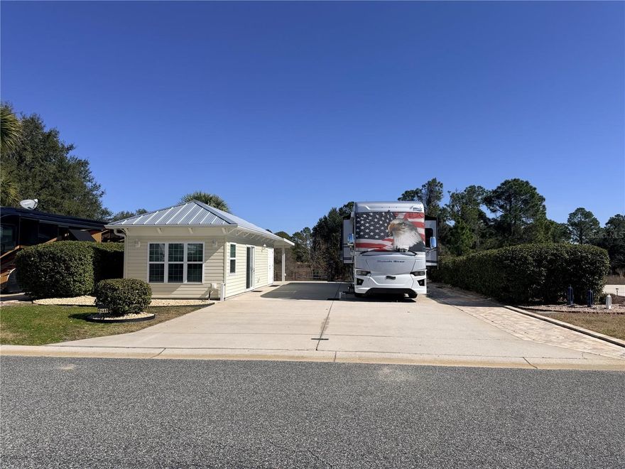 Welcome to your private slice of paradise in Florida Grande Motor Coach Resort. This 
beautifully improved 5,076 sq ft property combines peaceful pastoral views with modern luxury 
in one of Central Florida’s most sought-after Class A and Super C motorcoach communities. 
The 26’x76’ reinforced concrete pad offers full hookups and generous space for your coach, 
vehicles, and outdoor living. Adjacent pastureland creates an open, scenic backdrop, complete 
with a charming windmill that becomes part of your everyday view. Boundary hedges provide 
exceptional privacy, allowing you to fully relax and enjoy the quiet country setting. A 12’x16’ 
covered patio invites you to unwind outdoors, while extra pavers along the pedestal side of the 
pad and behind the Suite add both function and flexibility. Two storage sheds convey with the 
sale and are neatly tucked behind the Grande Suite to keep your space clean and organized. 
The brand-new 384 sq ft Grande Suite, completed in spring 2025, is thoughtfully designed with 
upscale finishes throughout. Tile flooring runs wall to wall for a clean, modern feel. The L
shaped kitchenette offers an impressive amount of cabinetry, quartz countertops, and a beautiful 
backsplash that elevates the entire space. The full bathroom features a tile shower with heavy 
glass doors and a vanity that perfectly matches the kitchenette cabinetry for a cohesive, designer 
look. A washer and dryer convey, along with a water softener for the coach house making this 
property truly move-in ready. 
Florida Grande is a gated, deeded motorcoach resort known for its oversized lots, active lifestyle, 
and welcoming community. Owners enjoy a clubhouse with pool and spa, fitness center, 
pickleball courts, dog park, planned social events, and a calendar full of activities that make it 
easy to meet neighbors and feel at home. The resort’s inland location provides peace of mind 
while still placing you within easy reach of Orlando, Tampa, the Gulf Coast, and endless day-trip 
adventures. Whether you’re seeking a seasonal retreat or a full-time base, Florida Grande offers 
the perfect blend of relaxation, recreation, and connection. 
Experience the lifestyle that keeps owners coming back year after year