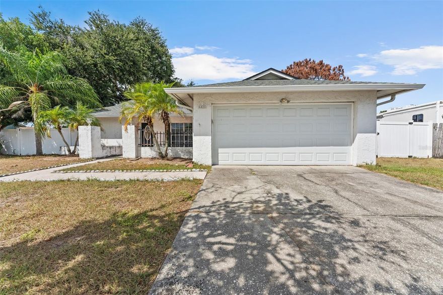 Welcome to this spacious 3-bedroom, 2-bath home with a 2-car garage located in the desirable Logan Gate Village community. This home offers solid bones and great potential—perfect for anyone looking to add their personal touch!
Inside, you’ll find an open-concept living and dining area with vaulted ceilings and plenty of natural light. The kitchen features appliances including a range, microwave, dishwasher, and side by side refrigerator, generous counter space, and a breakfast bar that opens to the dining area, making it ideal for everyday living and entertaining. Fresh interior paint (2025) brightens the entire home.
Major updates include a roof (2020), A/C (2018), vinyl fencing (2020) for added privacy, and a garage door with new tracks (2020). The expansive screened lanai offers endless possibilities for relaxation or outdoor gatherings, with room for a seating area and outdoor kitchen setup. The hot tub is non-functional, but the space can easily be repurposed or restored.
Logan Gate Village offers a wonderful sense of community and features a scenic pond and playground right at the entrance—perfect for families, joggers, and anyone who enjoys the outdoors. The location is unbeatable, with easy access to top-rated schools, Citrus Park Mall, the Upper Tampa Bay Trail, Veterans Expressway, Tampa International Airport, Raymond James Stadium, and a wide variety of restaurants and retail. Plus, the Gulf beaches are just a short drive away, making weekend escapes a breeze. Don’t miss the opportunity to make it yours. Schedule your private tour today!
