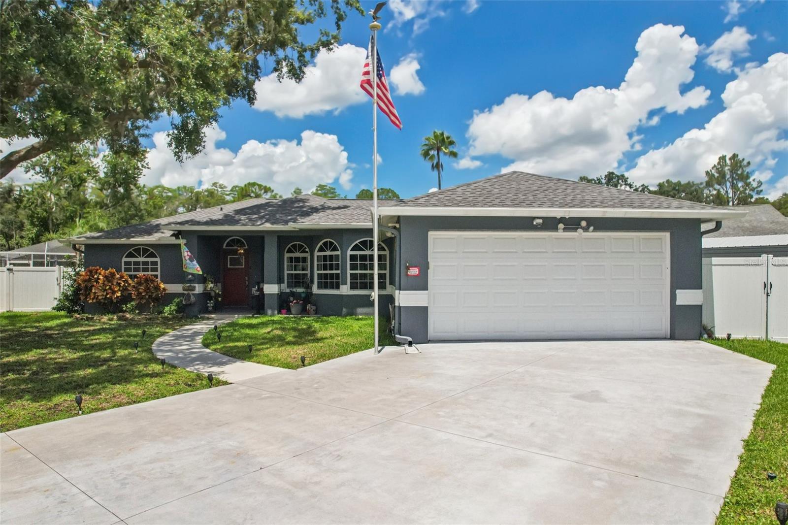 Welcome to this beautifully maintained 3-bedroom, 2-bathroom home located in the highly sought-after “Eagles Island Estates” community with no CDD and low HOA of $160 annually. Walking distance from top-rated Pineview Elementary and Middle Schools. No neighbors in front or in back of you. With 1,733 square feet of comfortable living space and a 2-car garage with epoxy (guardian) flooring, this home offers both functionality and charm. Step inside to find High ceilings and engineered hardwood floors flowing seamlessly throughout the main living areas. The updated kitchen features stylish shaker cabinets, granite countertops, a breakfast nook, and stainless-steel appliances, including a double oven—perfect for cooking and entertaining. The primary suite boasts a spacious walk-in closet, dual sinks, a garden tub, a separate water closet, and a private, spa-like atmosphere. Enjoy outdoor living at its best on the expansive 1,000 SF covered, screened, epoxy (guardian) floored lanai with a hot tub overlooking the tranquil canal. The vinyl fenced yard provides added privacy and security. Recent upgrades includes: HVAC (2021), ROOF (2024), TANKLESS WATER HEATER (2019), DRIVEWAY (2023), WINDOWS AND DOORS (2018-The front ones are hurricane impact), ALUMINUM SHED (2019), COVERED LANAI (2018). The home also entails a CCTV8 alarm system, central vac and a large pantry. It is conveniently located near major interstates, shopping, and dining. Zoned for top-rated schools, this home is move-in ready and waiting for you!