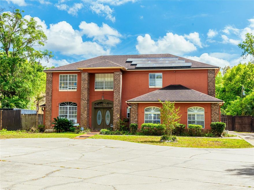 Discover this stunning home nestled on over an acre in the highly sought-after Ranch Lands, where you can enjoy the freedom of no HOA—offering ample space and proximity to Orlando, shopping, theme parks, beaches, and both Orlando and Sanford airports; pull into the oversized roundabout driveway and step into a bright living room, with access to the kitchen or a right turn to the second level featuring three bedrooms, a bath, a spacious primary bedroom with a walk-in closet, and an oversized primary bath, while the chef’s dream kitchen offers a butler’s pantry, a laundry room connected to the pool bath, and a cocktail wet bar—doors from both the kitchen and pool bath lead to a screened-in porch overlooking the inviting pool, and nearby a large additional pantry with two fridges and a freezer provides shared access to the in-law suite with its own kitchen, living room, two bedrooms, and a bath plus a separate wheelchair-accessible entrance from the driveway and gate; the property also features a large garage/barn at the rear, comes equipped with solar panels, and includes a new AC installation before closing for peace of mind—bring your vision and turn this beautiful property into your family compound oasis, and book your showing today (the last two) pictures include renderings we did to show how the home can look for an alternate style).