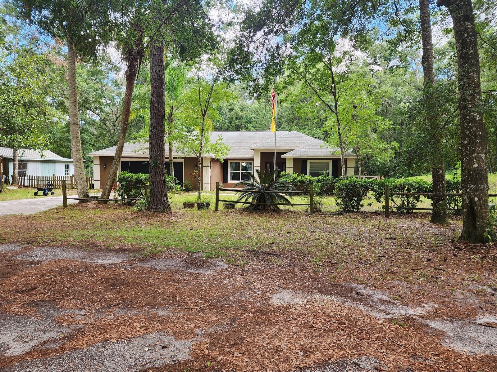 Welcome to your private oasis! As you approach, you’ll immediately appreciate how far the home is set back from Citrus Way, offering privacy, serenity, and a beautiful view of the semi-cleared yet naturally wooded 4-acre lot. This cross-fenced property is perfect for animal lovers, with a dedicated dog run and a large agility training area ready for your four-legged companions. Bring your horses, dogs, pigs—there’s room for all!
Ideal for both peaceful living and entertaining, this spacious property features ample parking, a circular driveway for easy access, and covered RV or boat storage. You’ll also find a Level 2 electric vehicle charging station and a generator-ready hookup system—just plug in your generator and keep your essential devices running in case of a power outage.
Inside, the home is beautifully updated and thoughtfully designed. With 3 bedrooms, 2 bathrooms, and 2,088 square feet, there’s space to spread out and truly feel at home. The large kitchen features an island bar—perfect for hosting guests or enjoying everyday meals—and multiple living areas including a formal dining room and a cozy family room.
If sustainability and nature are important to you, you'll love the self-sustaining hydroponic garden with tilapia—a closed-loop system where fish nourish the garden and the garden filters the water for the fish. Enjoy fresh vegetables and fish year-round!
Additional highlights include:
Large Air Conditioned Workshop,
Whole house water softener and filter,
Smart thermostat,
High Speed Internet,
Deep well water with no sulfur taste or iron deposits,
Quiet, peaceful surroundings and natural beauty,
Tons of space for gardening, hobbies, and outdoor activities,
Tastefully updated interior, move-in ready,
Flexible use of land for livestock, recreation, or expansion.
Whether you’re looking for a hobby farm, a sustainable homestead, or just a peaceful retreat with modern amenities, this one-of-a-kind property has it all. Come experience the perfect blend of nature, comfort, and practicality!