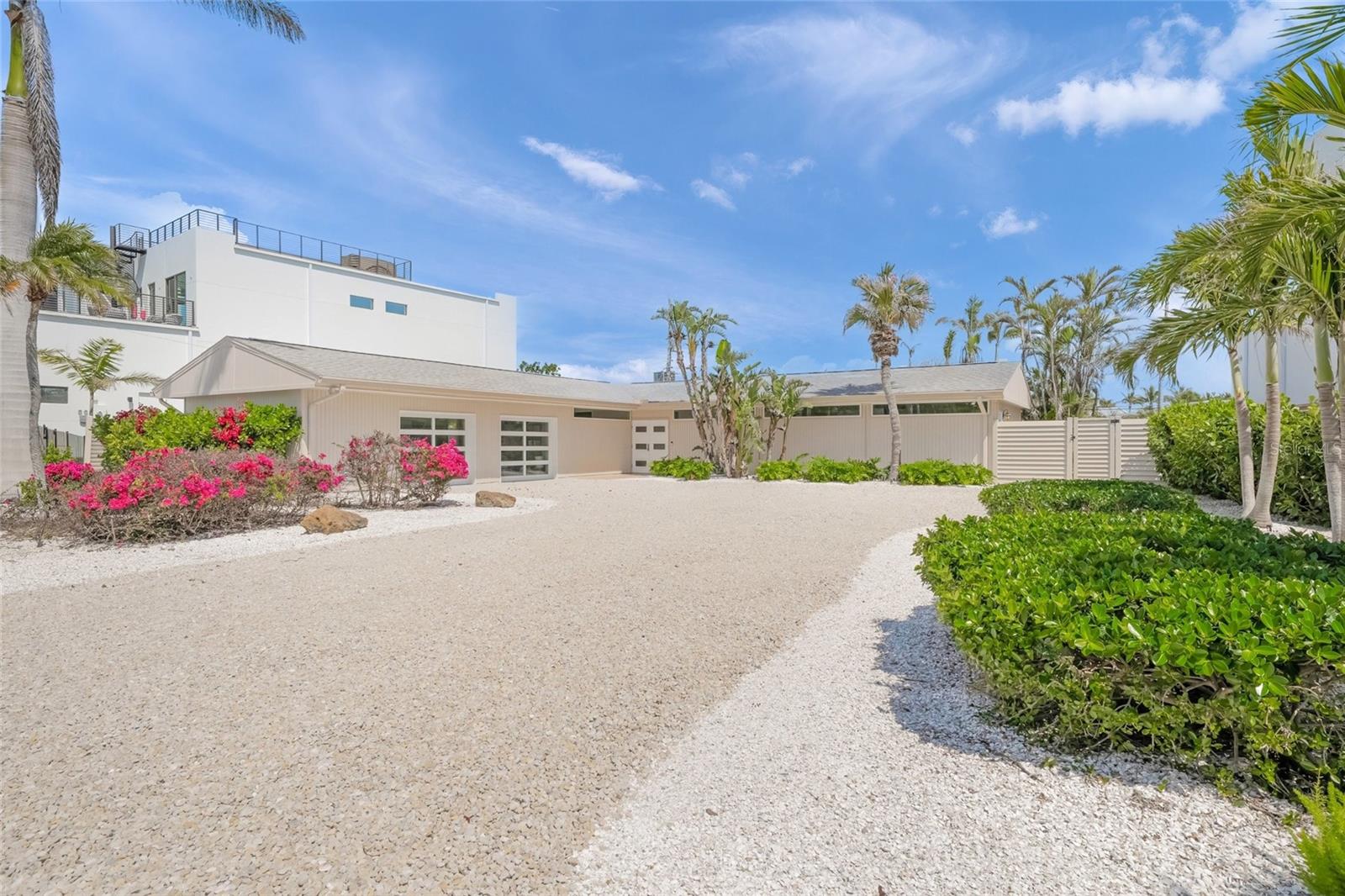 Discover a beautiful, serene beachside sanctuary at 1186 Center Place, where timeless sophistication meets coastal allure. This impeccably redesigned home is nestled in the exclusive, architecturally significant Lido Shores neighborhood. This mid-century modern gem boasts deeded beach access to the white sandy shores of Lido Beach, a 3-minute walk away. This home defines the pinnacle of upscale Florida living. As you approach, tropical landscaping, vibrant blooms, and a chic shell-and-stone driveway usher you toward a classic contemporary exterior.
Step through the stylish double-door entrance into a home completely reimagined with meticulous attention to detail. The open-concept design unites living, dining, and kitchen areas, bathed in natural light streaming through expansive floor-to-ceiling windows and sliding glass doors. Gleaming original terrazzo floors and sleek built-ins create a harmonious blend of form and function.
At the heart of this exceptional residence is the gourmet kitchen—luxurious yet practical—with premium stainless-steel appliances, quartz countertops, contemporary cabinetry, and a spacious island perfect for culinary exploration and casual entertaining. Retreat to the expansive primary suite, where custom cabinetry and plantation shutters frame tranquil views of your private outdoor haven.
Step outside to an outdoor retreat that redefines luxury living. A meticulously paved patio, shaded by stylish designer umbrellas, beckons for al fresco dining or cozy evenings by the fire pit. Encircled by mature tropical foliage, this secluded backyard offers a peaceful escape in your private paradise.
Just steps from your door, the Gulf of Mexico’s shimmering waters await, with deeded beach access granting you effortless enjoyment of Sarasota’s pristine shores. A short stroll brings you to world-class dining, boutique shopping, cultural treasures, and endless recreation, blending convenience with coastal refinement.
At 1186 Center Place, experience the pinnacle of coastal sophistication tailored for discerning buyers who appreciate elegance, style, and Florida’s ultimate beach lifestyle.